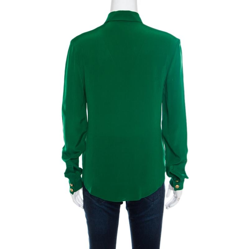 This lovely green shirt from Balmain is one creation you definitely need to get your hands on! It is made of 100% silk and features sharp collars, gold-toned front button fastenings, twin chest pockets, and long sleeves. Pair it with slim fit jeans