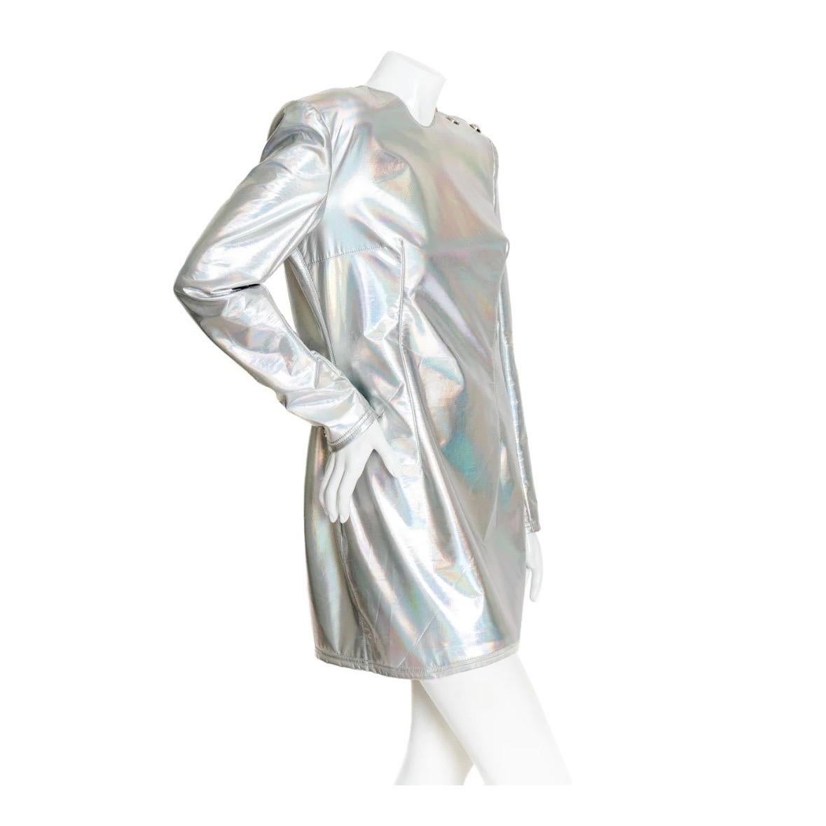 Holographic silver mini dress by Balmain
Silver Iridescent coated
Long sleeve
Round neckline
Silver buttons on shoulder
Exposed back zipper
Shoulder pads 
Darted bust
Cuff buttons
Stretch knit
Fully lined
Short, mini length
Stretchy bodycon