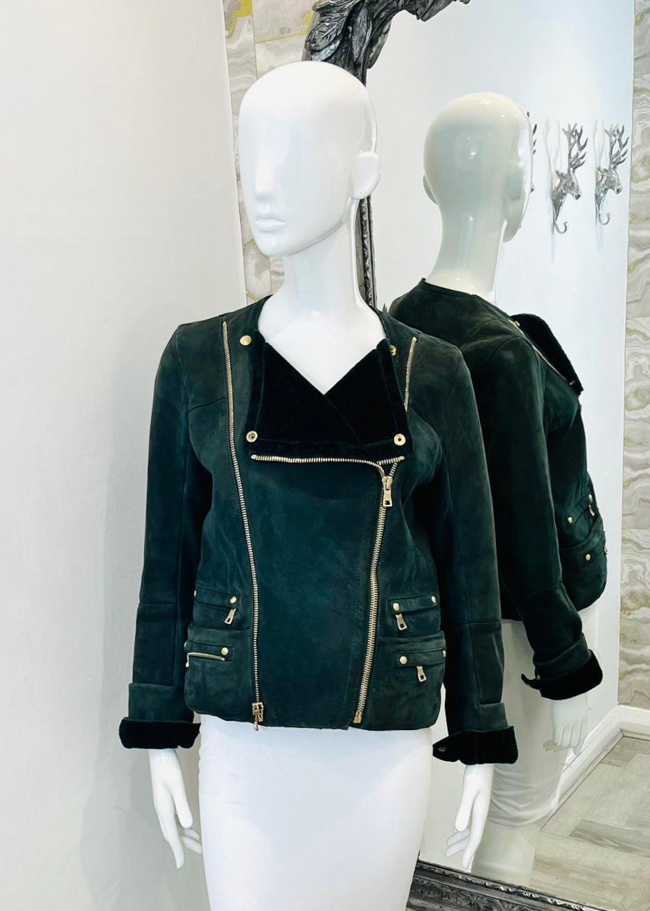 Balmain Lambskin Suede Biker Jacket

Dark green jacket designed with asymmetric zip fastening and four zipped pockets to the sides.

Detailed with gold Eagle embossed buttoned cuffs, dual zip accent and padded shoulders.

Size – 40FR

Condition –
