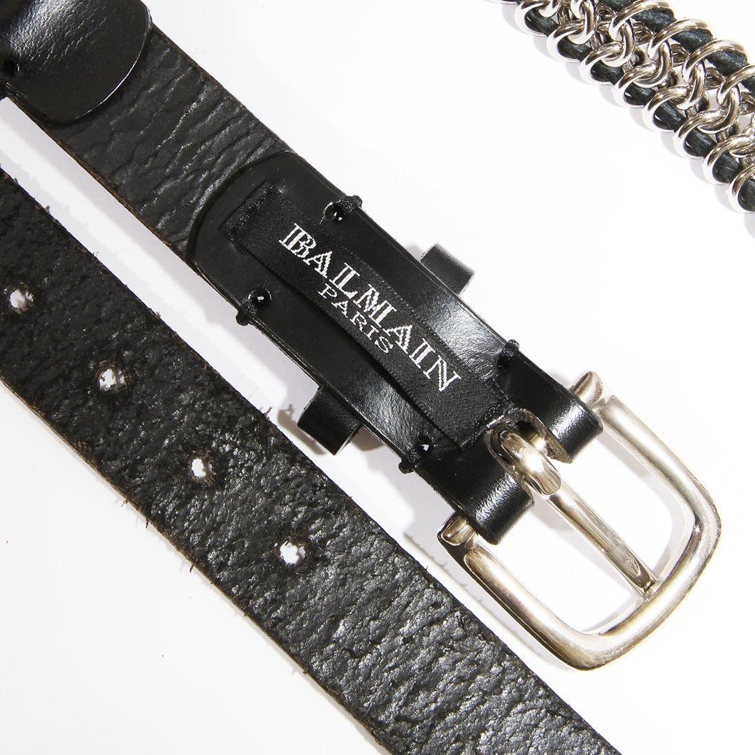 Chain belt by Balmain 
Circa 2009 
Black leather
intertwined chain
silver-tone hardware 
Buckle
Condition: Good, Consistent with wear and age. significant interior leather wear.  Some markings and scratches on metal. 

Size/Measurements: