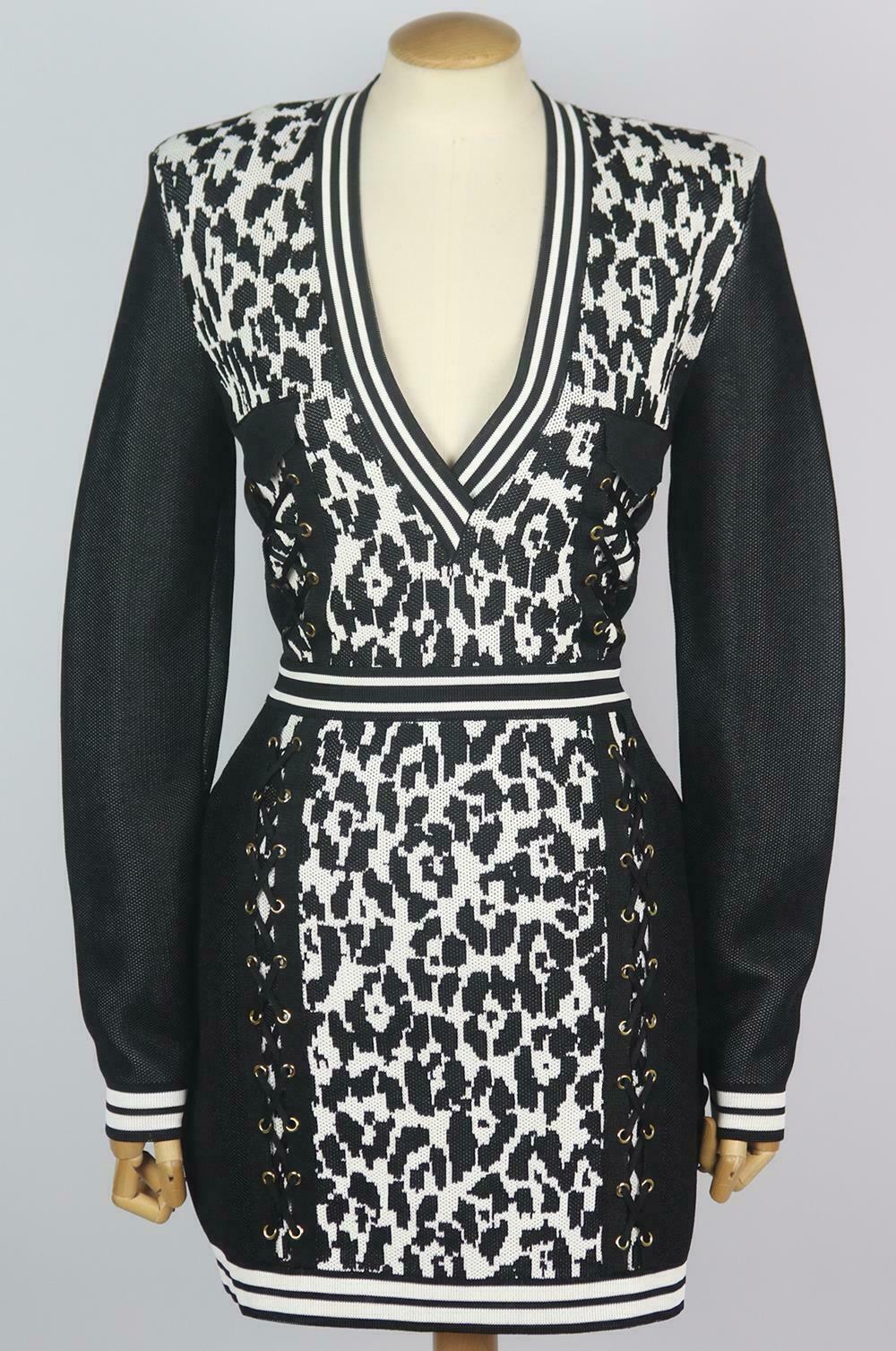 This Balmain dress has been crafted from stretch-knit and is designed with lace-up down the front on each side, it has strong shoulder pads and fits for a slim silhouette and is finished off with a leopard jacquard-knit.
Black and white