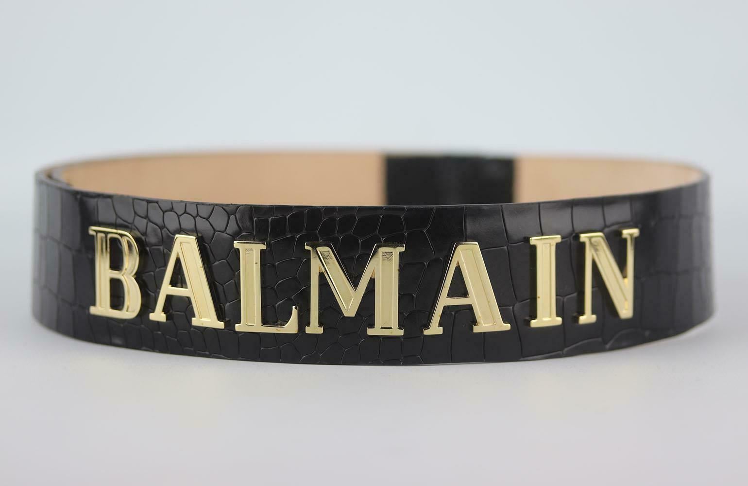 We can always count on Balmain for a glamorous finishing touch - this waist belt is made from soft croc-embossed leather, it has 'BALMAIN' across the front in gold and has snap fastening and you'll notice they're the same the lion-embossed buttons