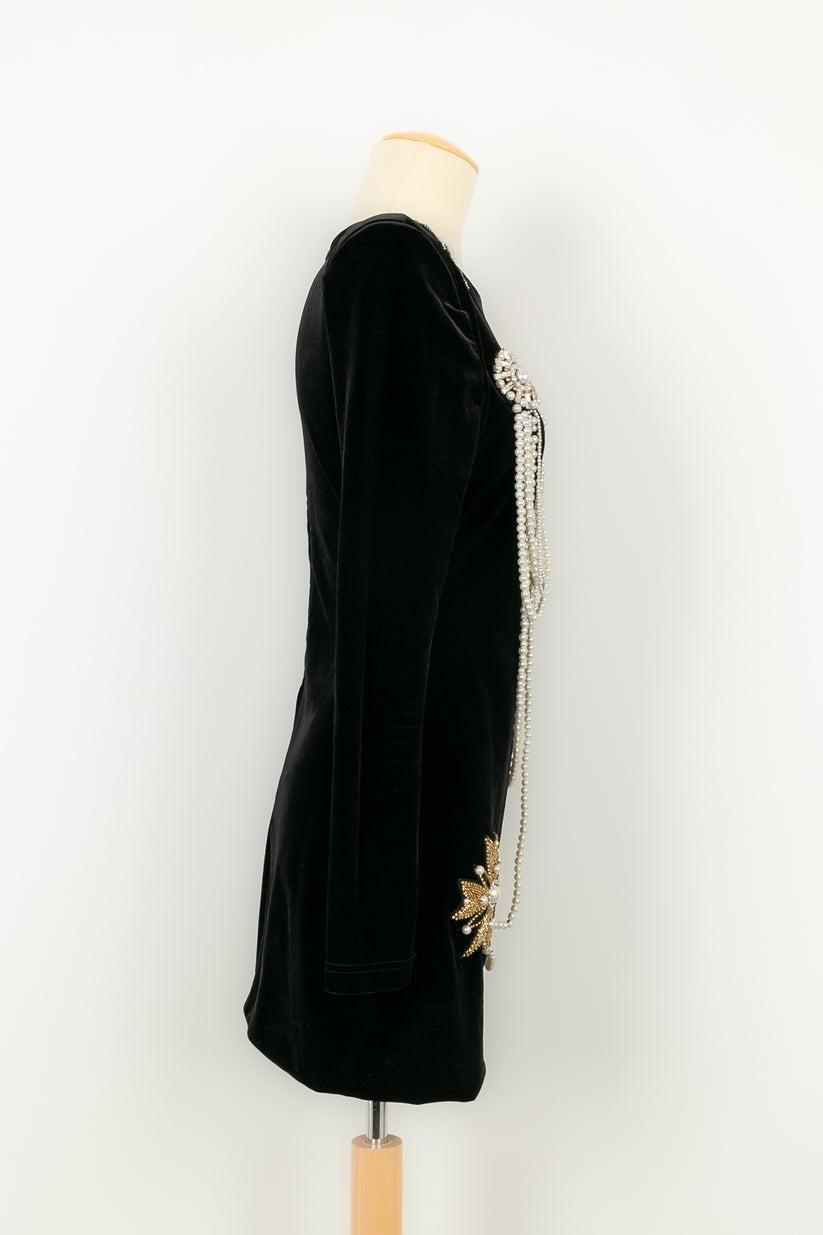 Balmain - Long-sleeved short dress in black velvet sewn with costume pearls and rhinestones. No size nor composition label, it fits a 36FR.

Additional information:
Condition: Very good condition
Dimensions: Shoulder width: 40 cm - Chest: 42 cm -
