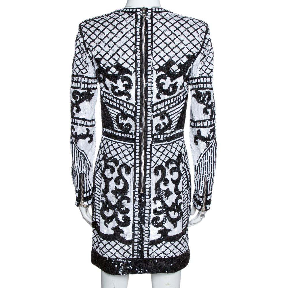 This gorgeous dress from the Baroque collection of Balmain is going to grab everyone's attention. The creation has intricately detailed sequins all over the dress that gives it a neo-classical look. It features zippers on the long sleeves and one at