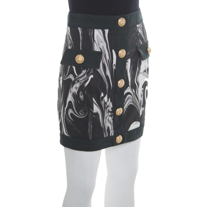 This mini skirt from Balmain is here to impress you with its fabulous design and style! It is made of a cotton blend and features a monochrome marble print. It flaunts gold-tone buttons detailed on the front and comes equipped with a zip closure at