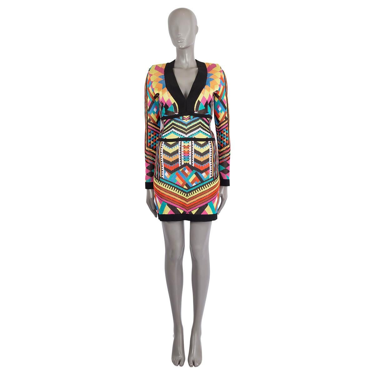 100% authentic Balmain geometric-print jacquard knit mini bodycon dress in multicolor viscose (100%). Features strong padded shoulders, V-neck, long sleeve and empire waist. Closes with a zipper in the back. Has been worn and is in excellent