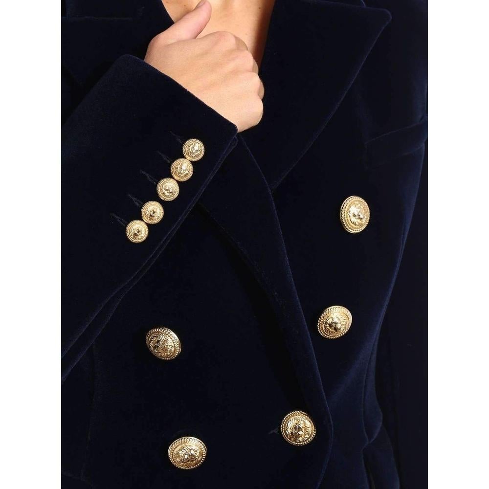 Navy classic double-breasted blazer.
Army style shimmering velvet double-breasted blazer detailed with padded shoulders and epaulettes,peak lapels, one chest pocket,
two front flap pockets and gold-tone logo engraved buttons.
Fully lined in