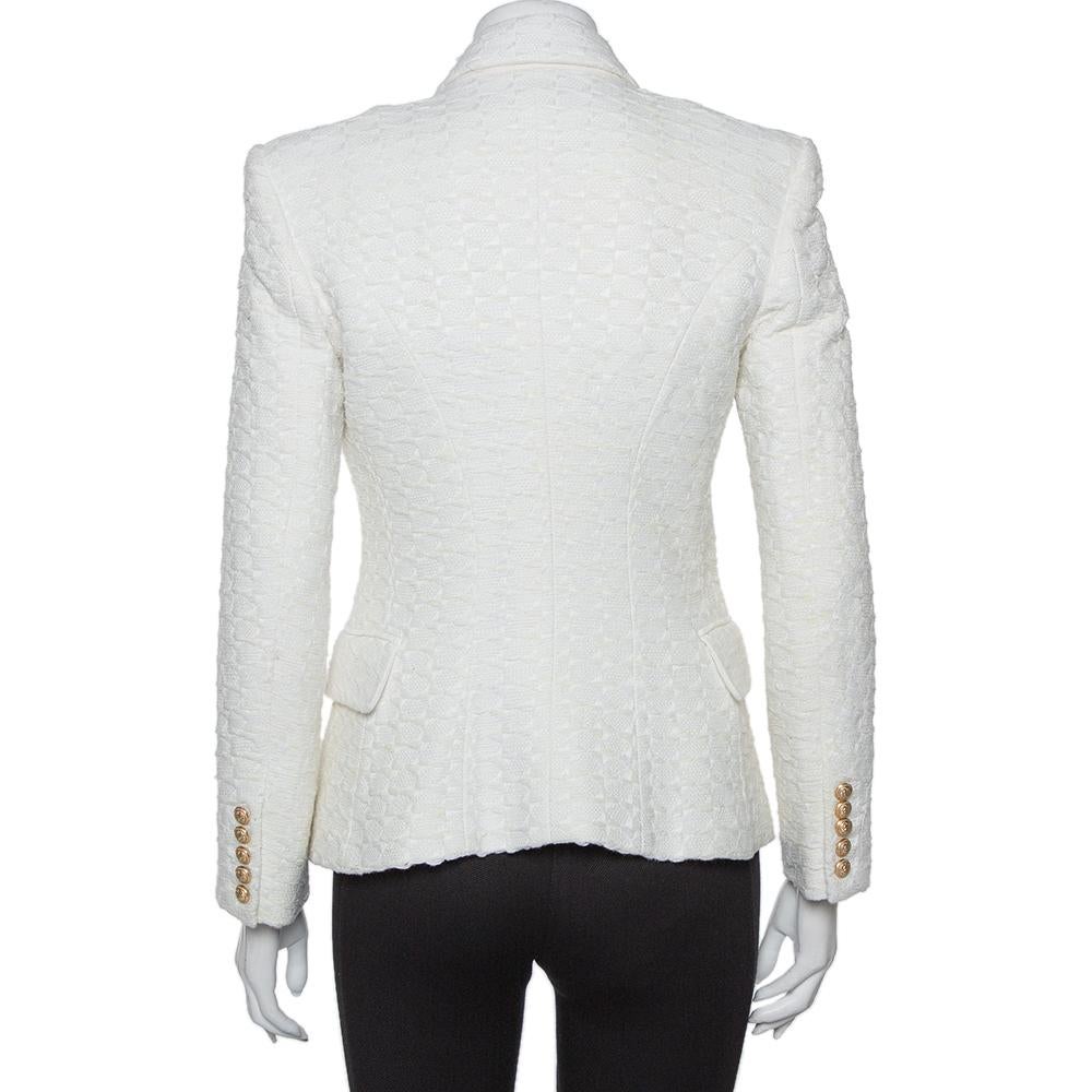 Add a touch of style with this brilliantly tailored Balmain blazer. Be fashionably prepared for anything that comes your way in this off-white tweed blazer. With a double-breasted style, gold-tone buttons, and smart fit, this blazer is a must-have!
