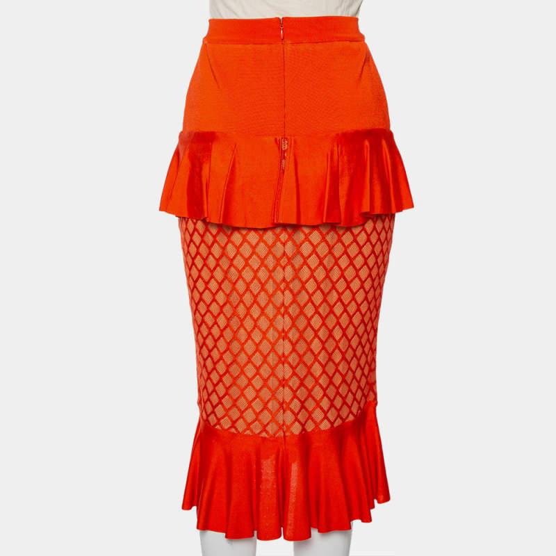 Designed using knit fabric, this Balmain orange midi skirt has a mermaid-esque style. It features ruffles, net-like panels, and a back zipper.

