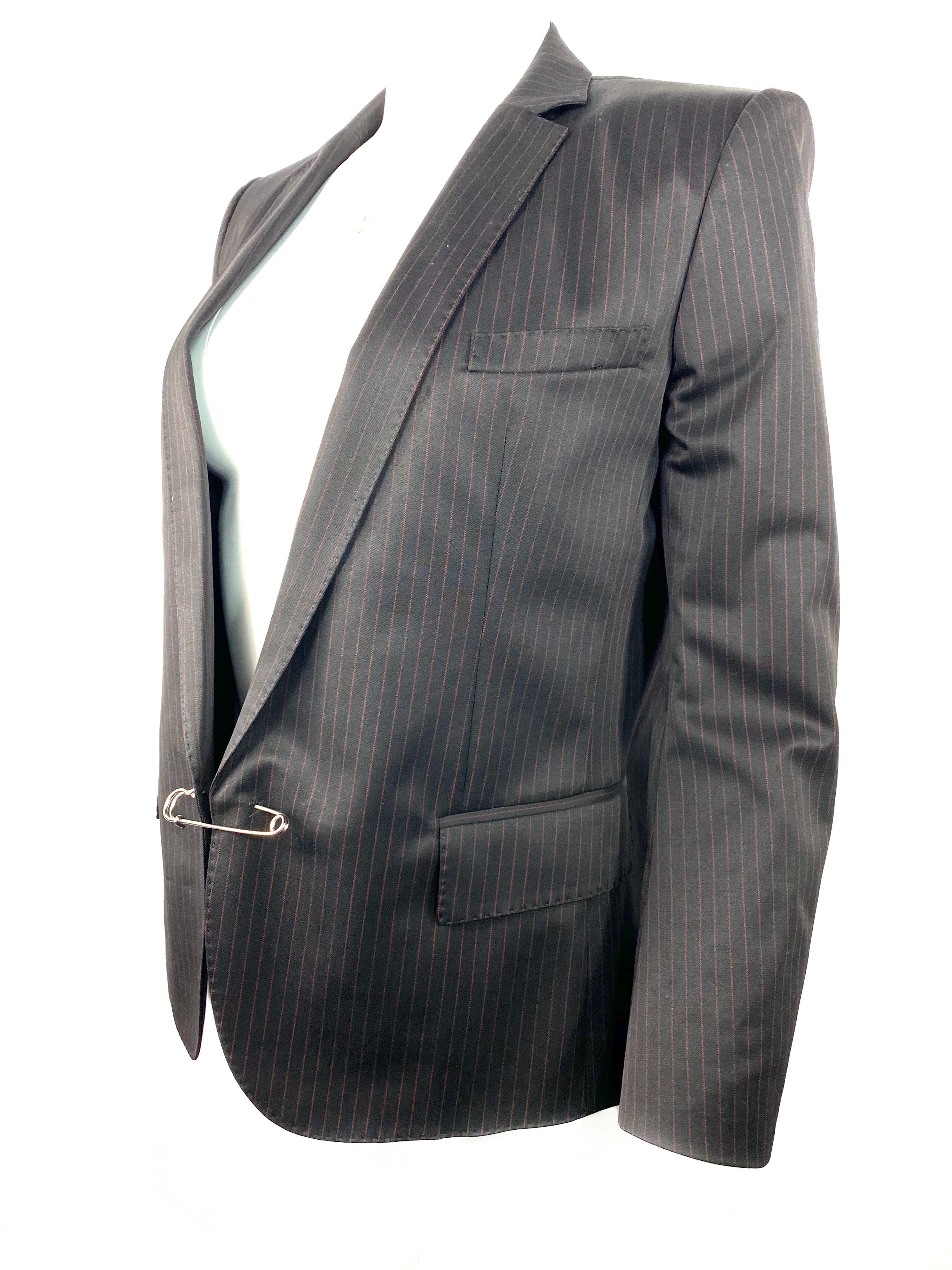 Product details:

Featuring back wool formal fit jacket with red thin vertical stripes and silver plated front safety pin closure.