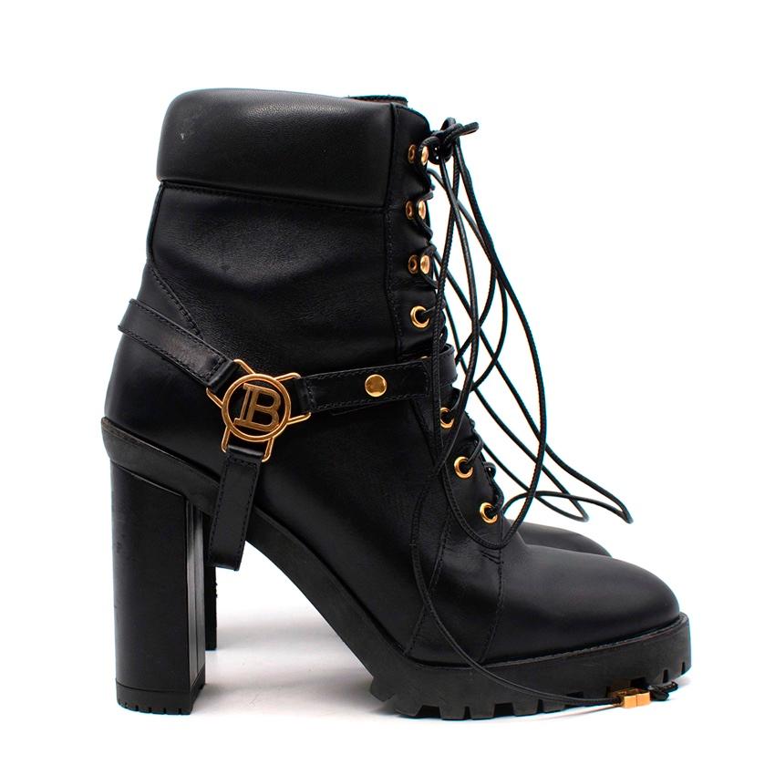 Balmain Petra Black Leather Heeled Combat Boots
 

 - Biker style boots with a tall leather wrapped block heel and chunky tread sole
 - Lace-up front, padded ankle cuff
 - Decorative black leather strapping with Balmain gold-tone metal logo plaque
