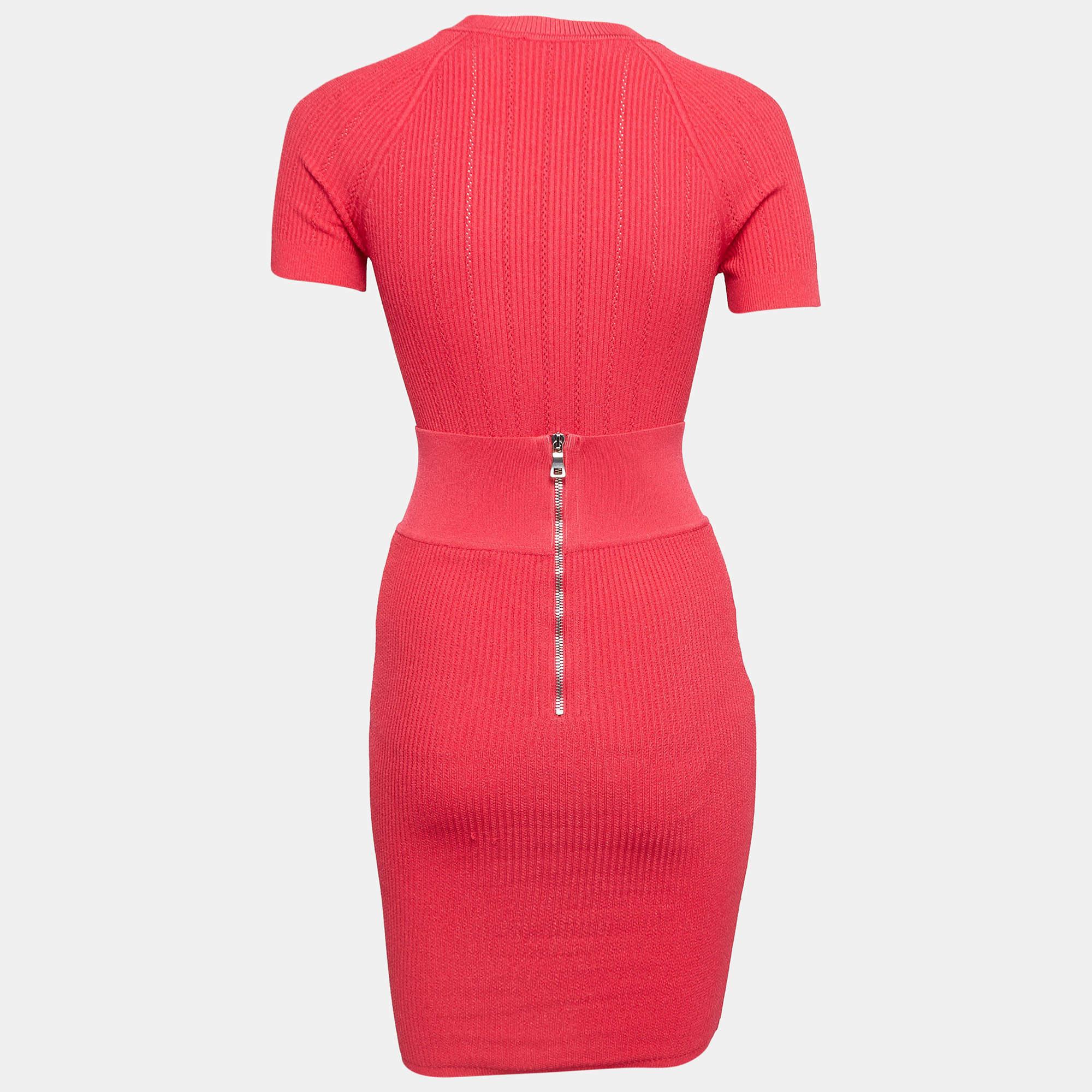 Balmains pretty skirt set comes in pink. The top and skirt are in rib knit fabric and they have a fitted design with button details. Style the set with sneakers to heels.