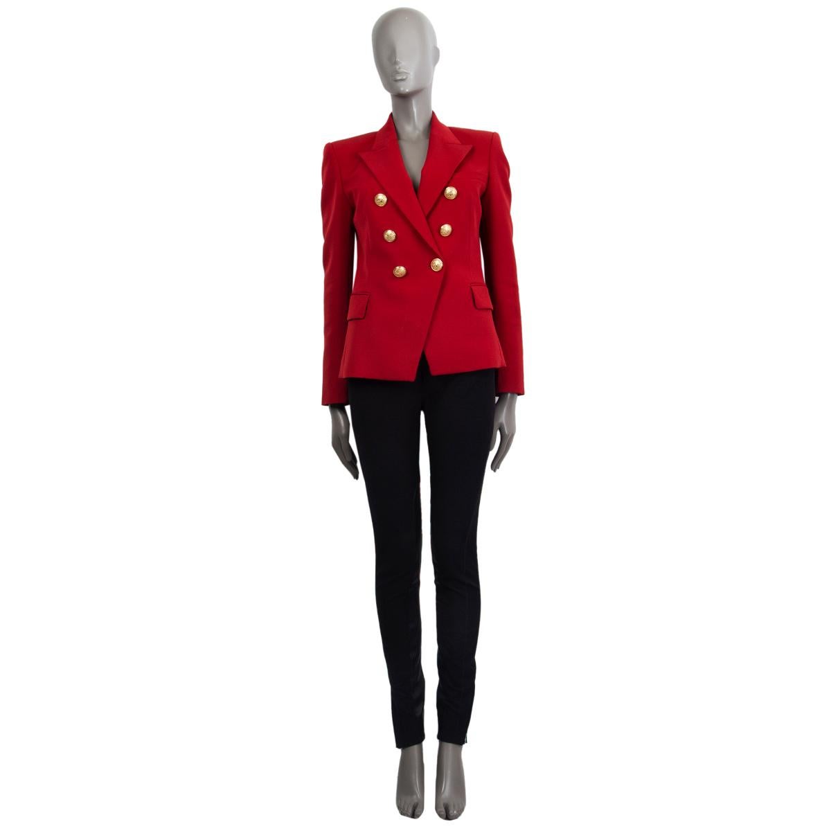 Balmain signature double-breasted blazer in deep red wool (100%) with a slim-fitting silhouette, one patch pocket on the chest, two flap pockets and buttoned cuffs at the back. Closes with embosses logo gold-tone buttons in the front. Lined in black