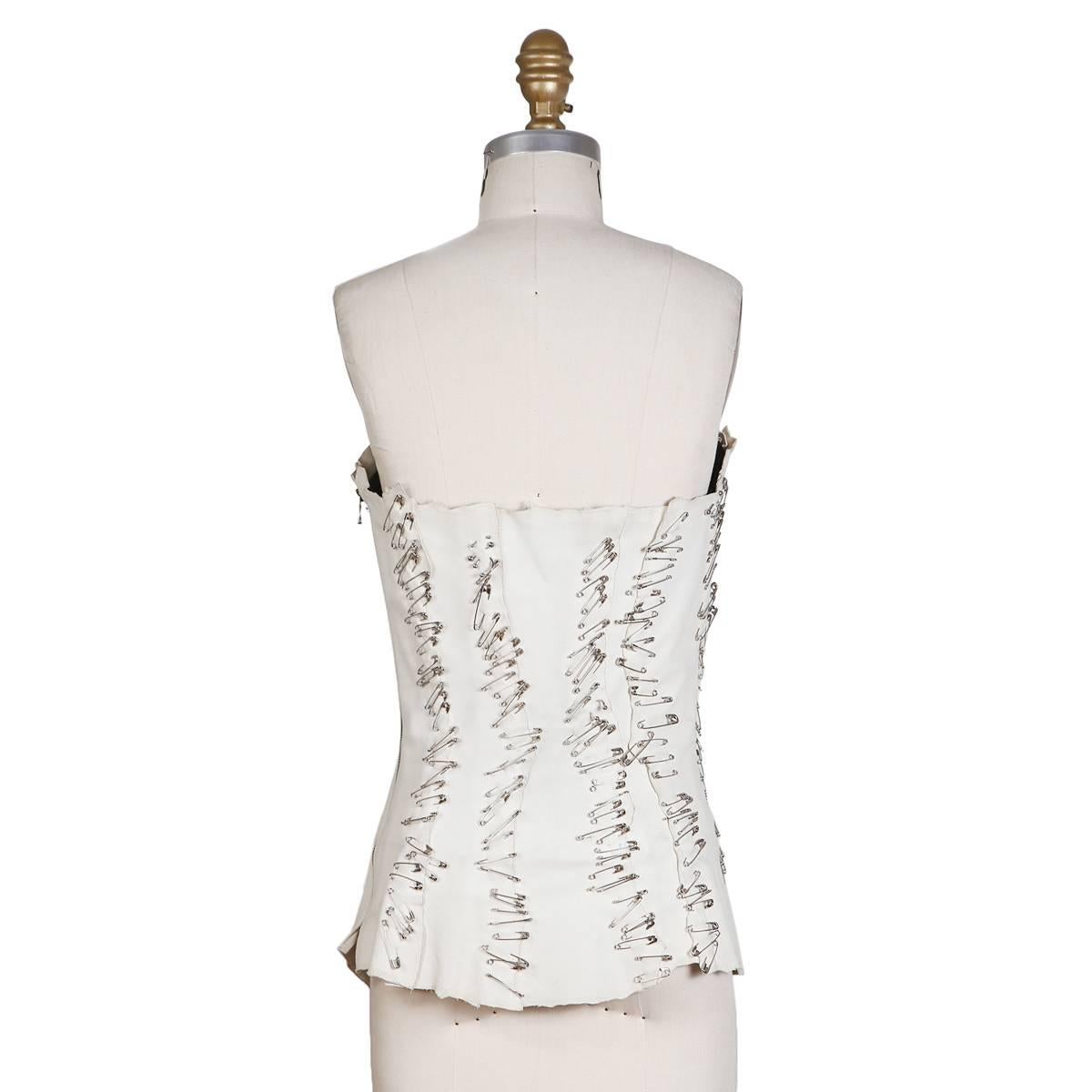 Bustier by Balmain for the S/S 2011-2012 RTW collection
White leather covered in safety pins
Side zipper closure
Condition: Good, with some wear and fading to the white leather

Size/Measurements:
Size 36
32