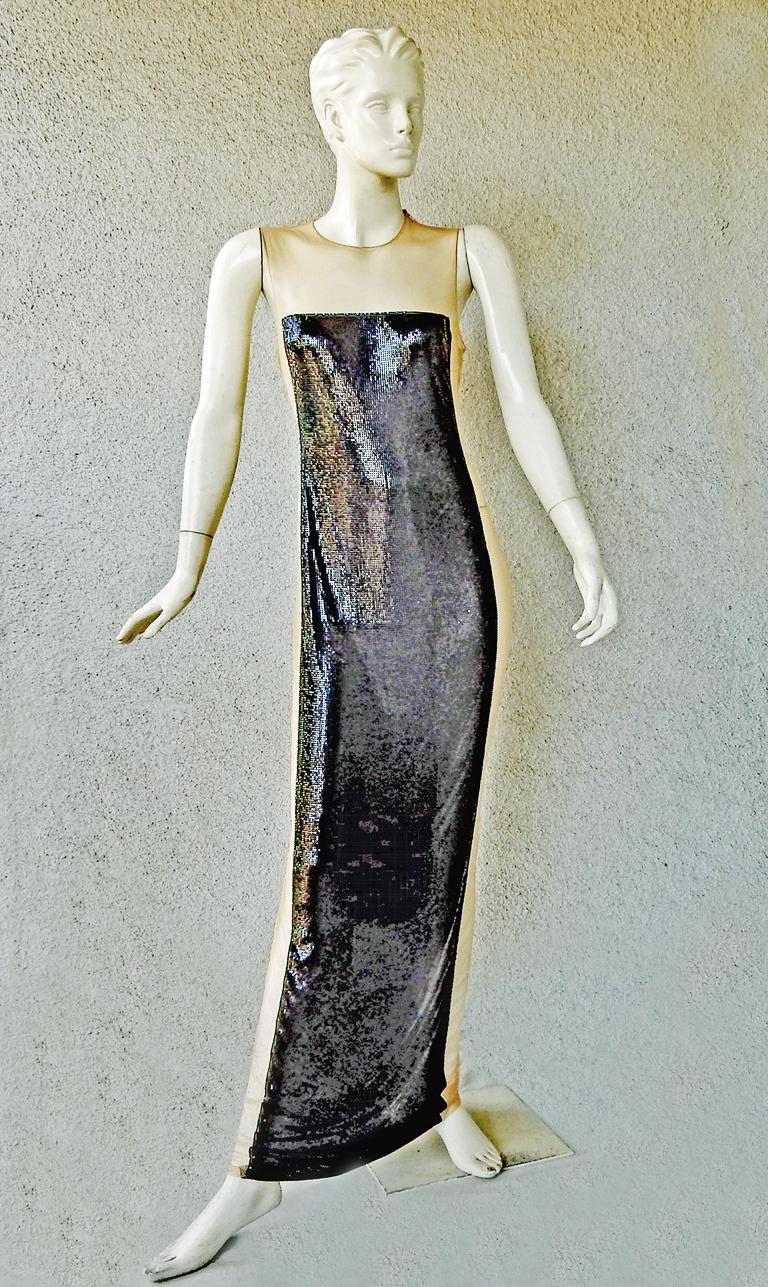 Stunning, seductive, and sleeveless elegant Balmain black chainmail gown with nude net enhancements. Tasteful nude long side panels, single shoulder zipper, and long side zipper.  One of the most exquisite and tasteful styles makes this a true