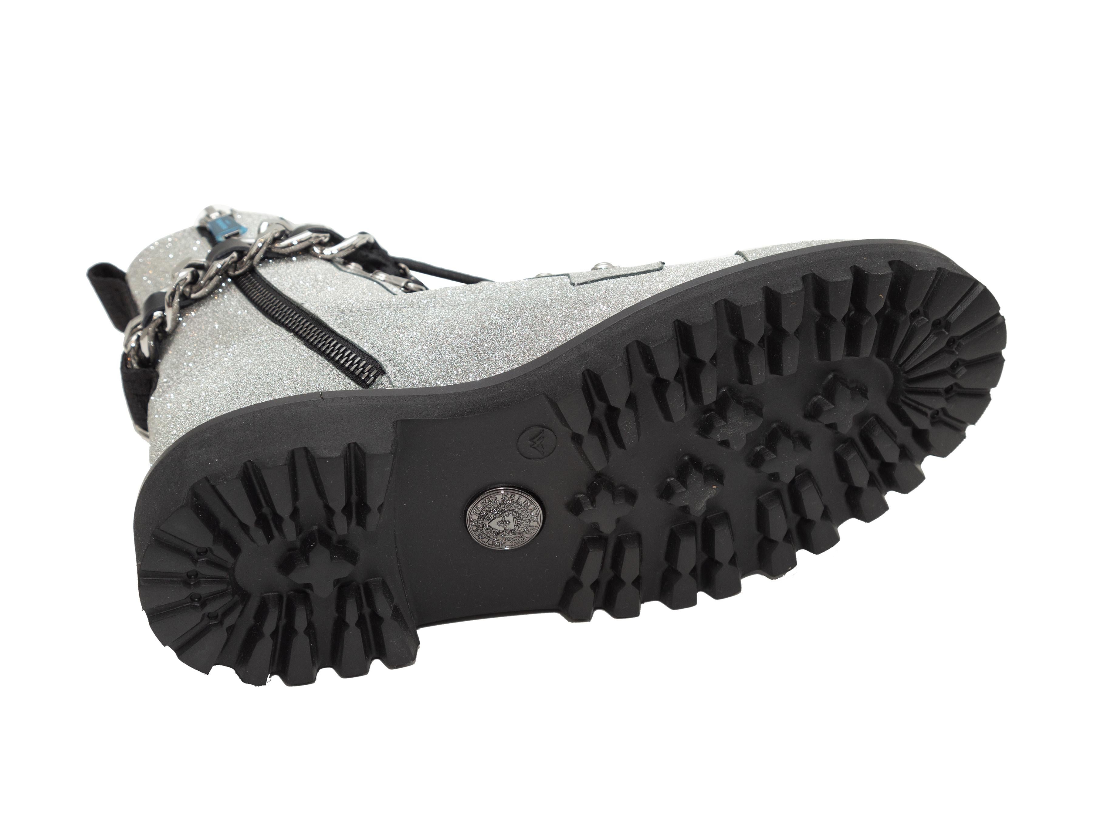 Product details: Silver glitter combat boots by Balmain. Silver-tone chain-link trim at lug soles. Chain-link, leather, and lace-up detailing at tops. Zip closures at inner sides. 1.25