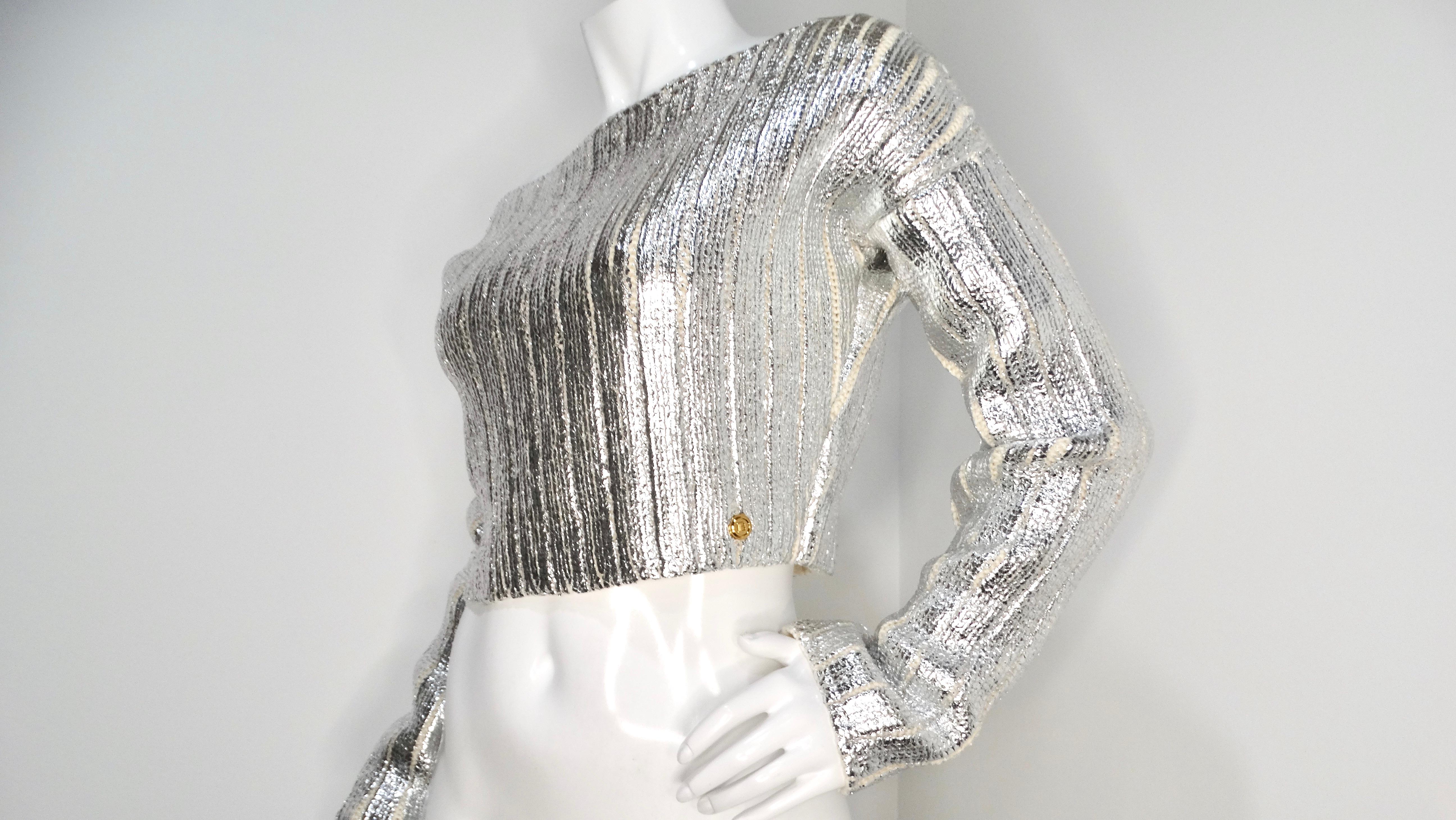The Balmain Silver Metallic Cropped Knit Sweater is a stunning addition to any fashion-forward wardrobe, brilliantly blending luxurious texture with contemporary style. Crafted from a soft cream knit, this striking piece is intricately adorned with