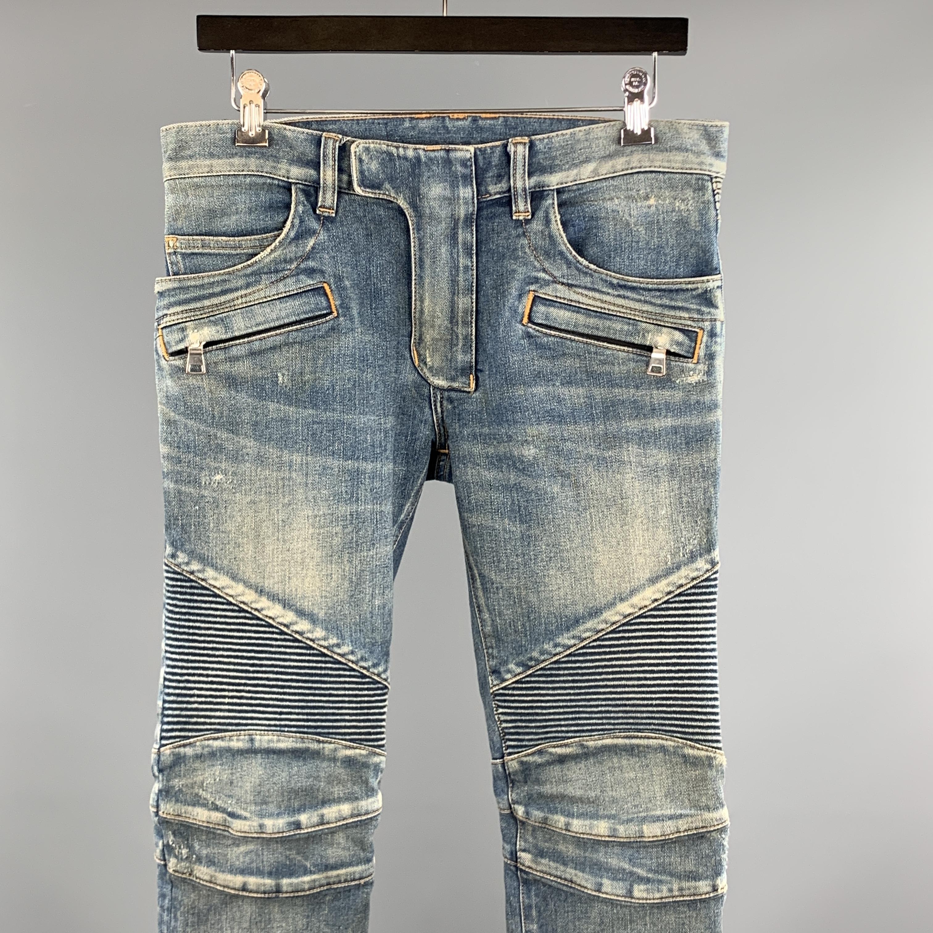 BALMAIN Jeans comes in a indigo wash denim featuring a biker style, ribbed knee panels, contrast stitching, zip fly, and a front tab closure. Made in Japan. 

Excellent Pre-Owned Condition.
Marked: 28

Measurements:

Waist: 28 in. 
Rise: 8 in.
