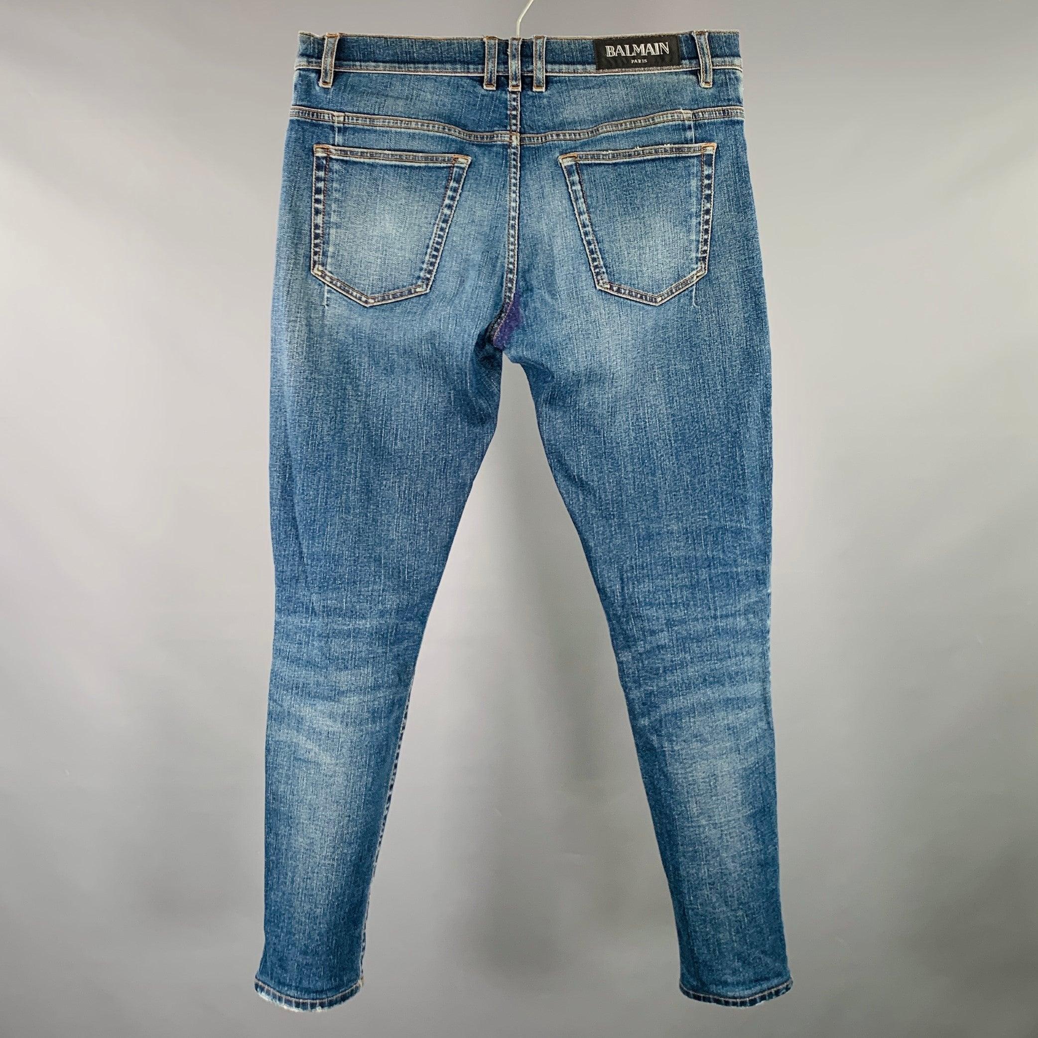 Vintage BALMAIN jeans
in a blue cotton stretch blend fabric featuring yellow contrast stitching, a double coin pocket design, and button fly closure. Made in Italy.Very Good Pre-Owned Condition. Repairs at crotch area, please check photos. As is.