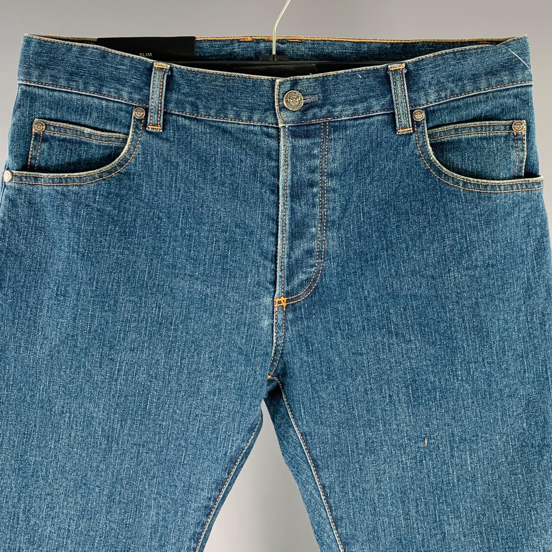 BALMAIN jeans
in a blue cotton blend woven denim featuring yellow contrast stitching, skinny fit, and button fly closure. Made in Japan.Excellent Pre-Owned Condition. 

Marked:   32 

Measurements: 
  Waist: 32 inches Rise: 8.5 inches Inseam: 31