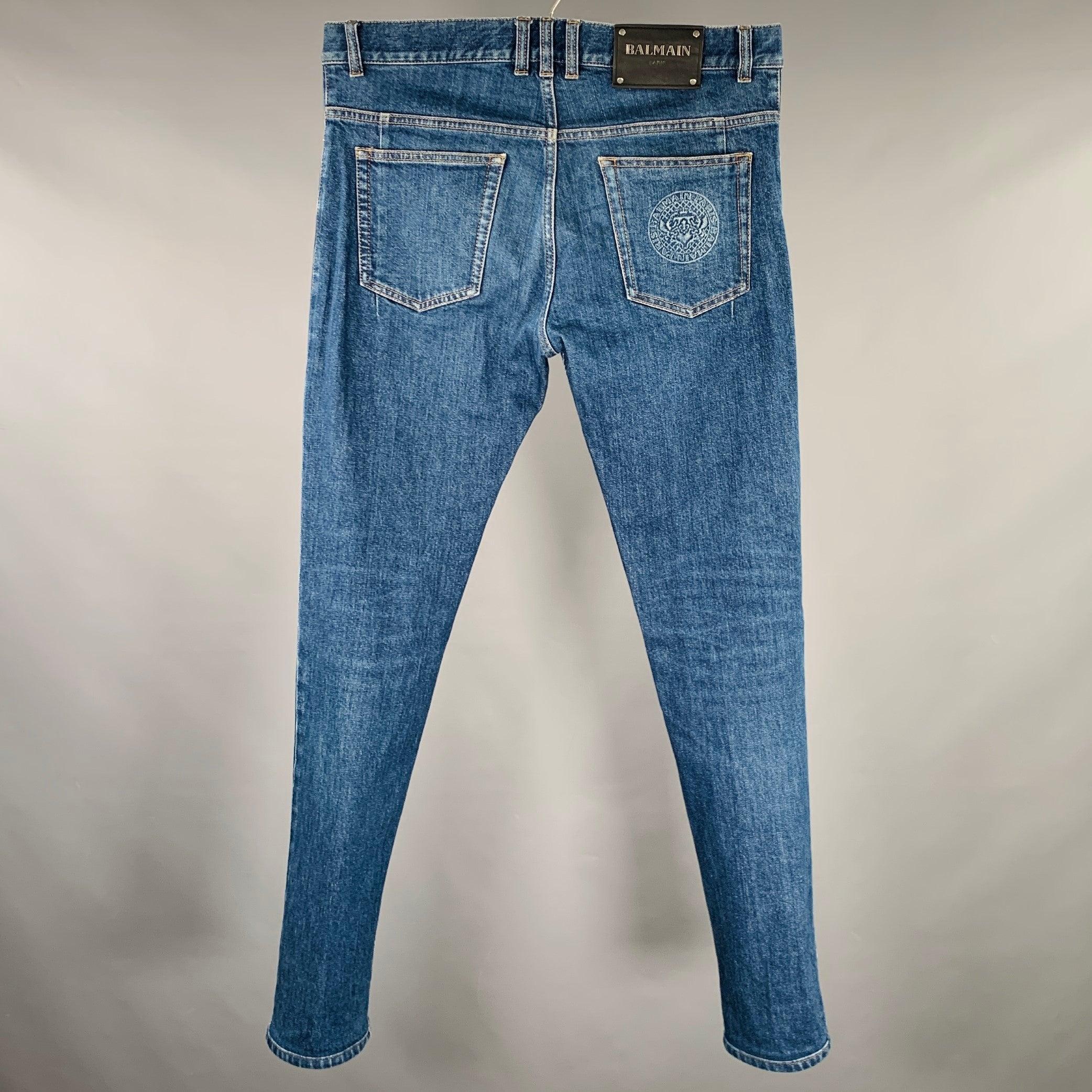BALMAIN jeans
in a blue cotton blend fabric featuring a five pockets style, tapered leg, and button fly closure. Made in Italy.Excellent Pre-Owned Condition. 

Marked:   32 

Measurements: 
  Waist: 32 inches Rise: 8.5 inches Inseam: 32 inches 
  
 