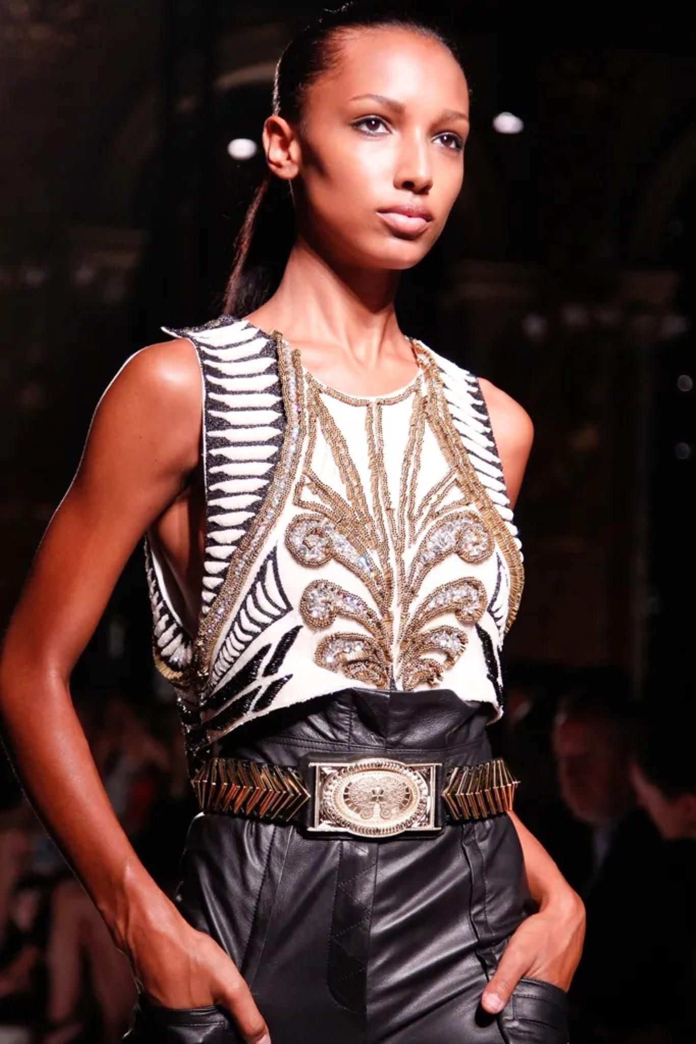 BALMAIN by Olivier Rousteing SS 2012 debut collection dress top comes in a white & black silk featuring a beaded design throughout, sleeveless, cropped, crystal embellishments, and a top shoulder button closure. Made in France. 

Excellent Pre-Owned