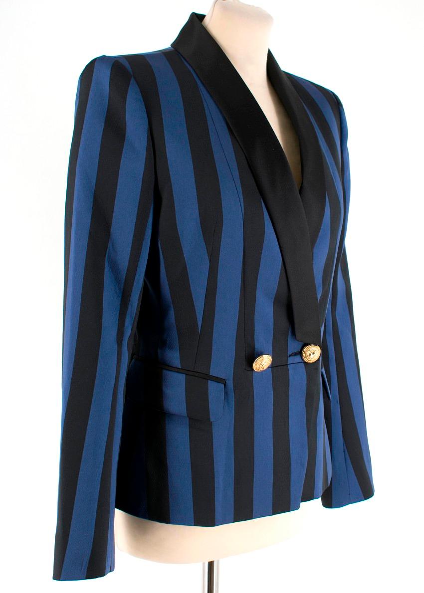 Balmain tailored blazer with black and blue stripes featuring peaked lapels, long sleeves, a fitted waist, flap pockets and gold-tone embossed buttons.

- Diagonal cuts
- Shoulder pads
- Long sleeves
- Button cuffs 
- Straight hem

Composition:
Main