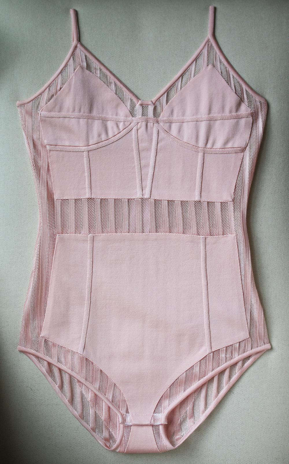 This pastel-pink bodysuit has carefully placed striped tulle panels that show a hint of skin. It's woven with raised boning-effect seams on the stretch-jersey bodice that enhance its figure-sculpting shape. Zip fastening along back, snap fastenings
