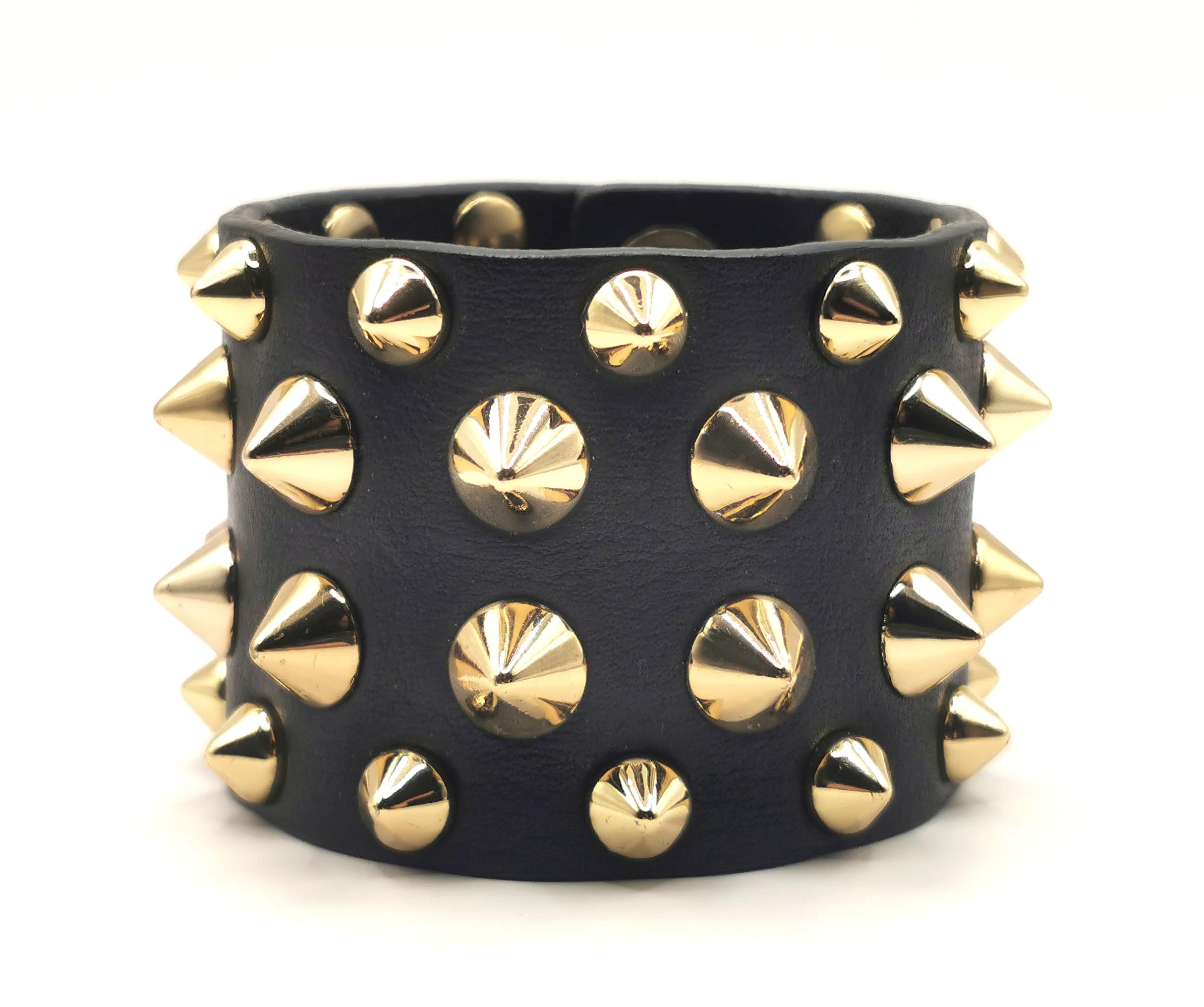 Channel your inner rock goddess with this fabulous Balmain black leather studded cuff bracelet.

Spiked gold studs adorn this wide and chunky soft black leather cuff bracelet.

It is easy to wear and full of attitude, the perfect piece for adding a