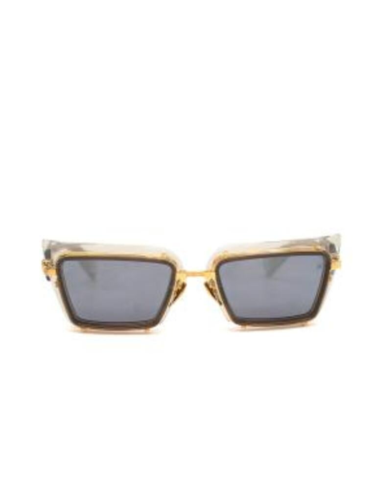 Balmain Translucent Admirable Sunglasses
 

 - Square cat eye clear grey acetate frames with golden metal border and hardware 
 - Grey lenses with slight reflective effect 
 - Logo on the arms and on one lens 
 - Golden adjustable nose rests 
 

