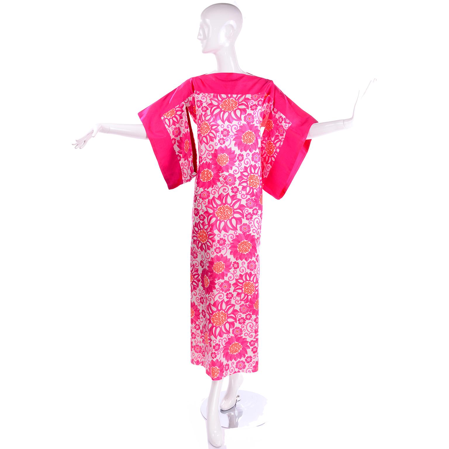 This is a gorgeous Thai Silk vintage maxi dress from Balmain in a mod bright floral print in shades of bright pink, white and orange.  We love the kimono style sleeves and the straight fit that makes this a dress that can be worn in the day or