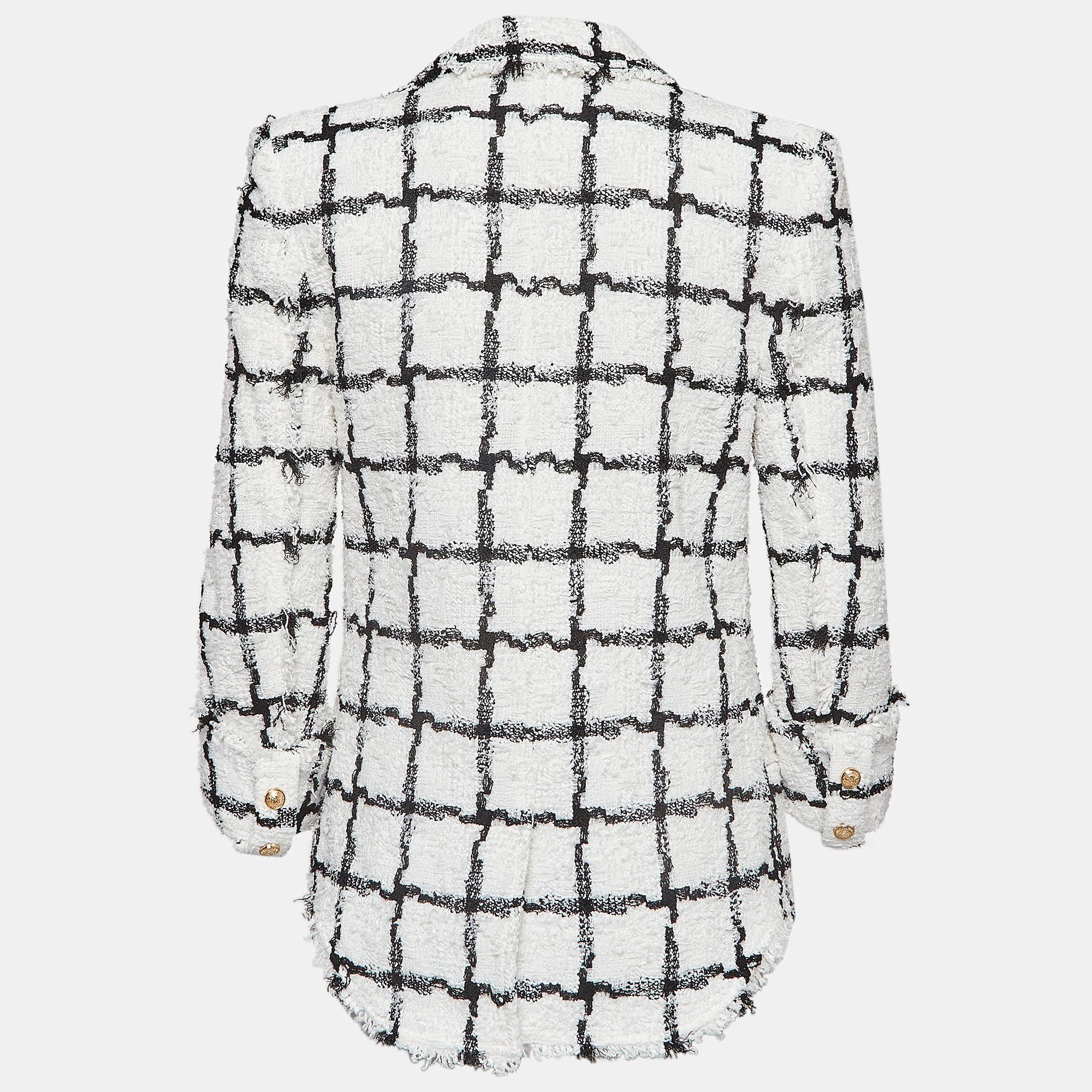 Balmain's flawless tailoring is unmatchable and this short dress exemplifies that. Made using tweed, the entire dress is covered in a check pattern The structured shoulders hark back to the iconic Balmain blazers and the fitted silhouette is perfect