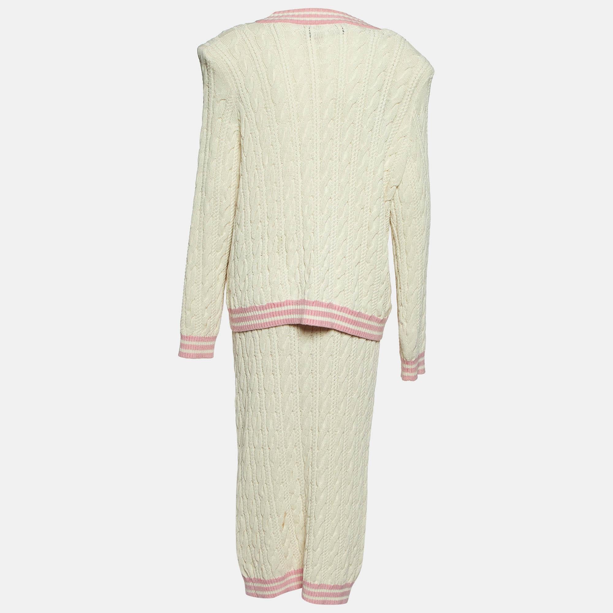 Discover timeless elegance with the Balmain set. Crafted from luxurious cable knit fabric  this chic ensemble features a fitted skirt with a stylish button front and a coordinating cardigan that exudes sophistication. Perfect for any occasion  this