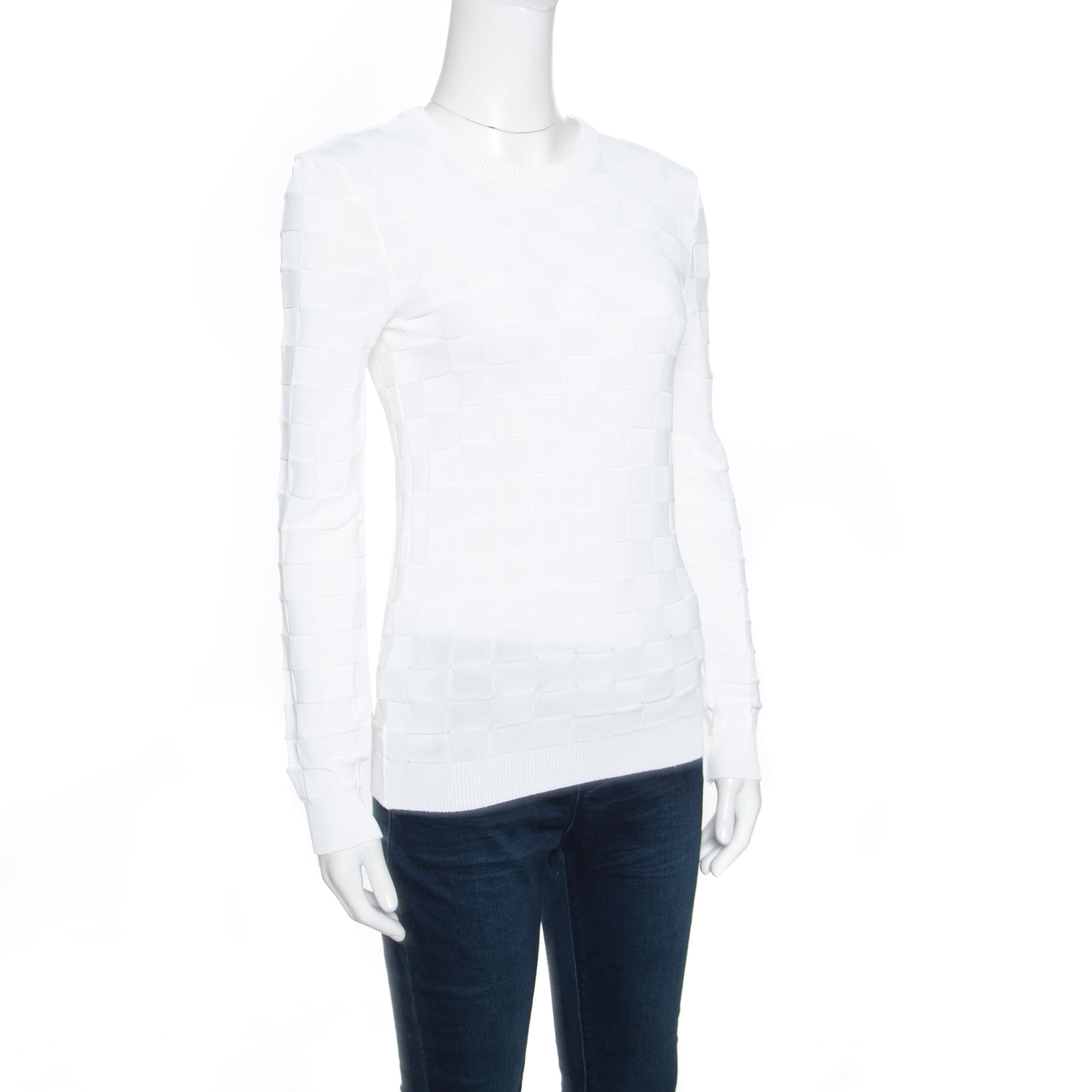 Balmain is known to create all that spells chic, classy and very modern! This white sweater is made of 100% viscose and features a simple structured silhouette. It flaunts a checkered knit pattern on it along with a crew neck and long sleeves. The