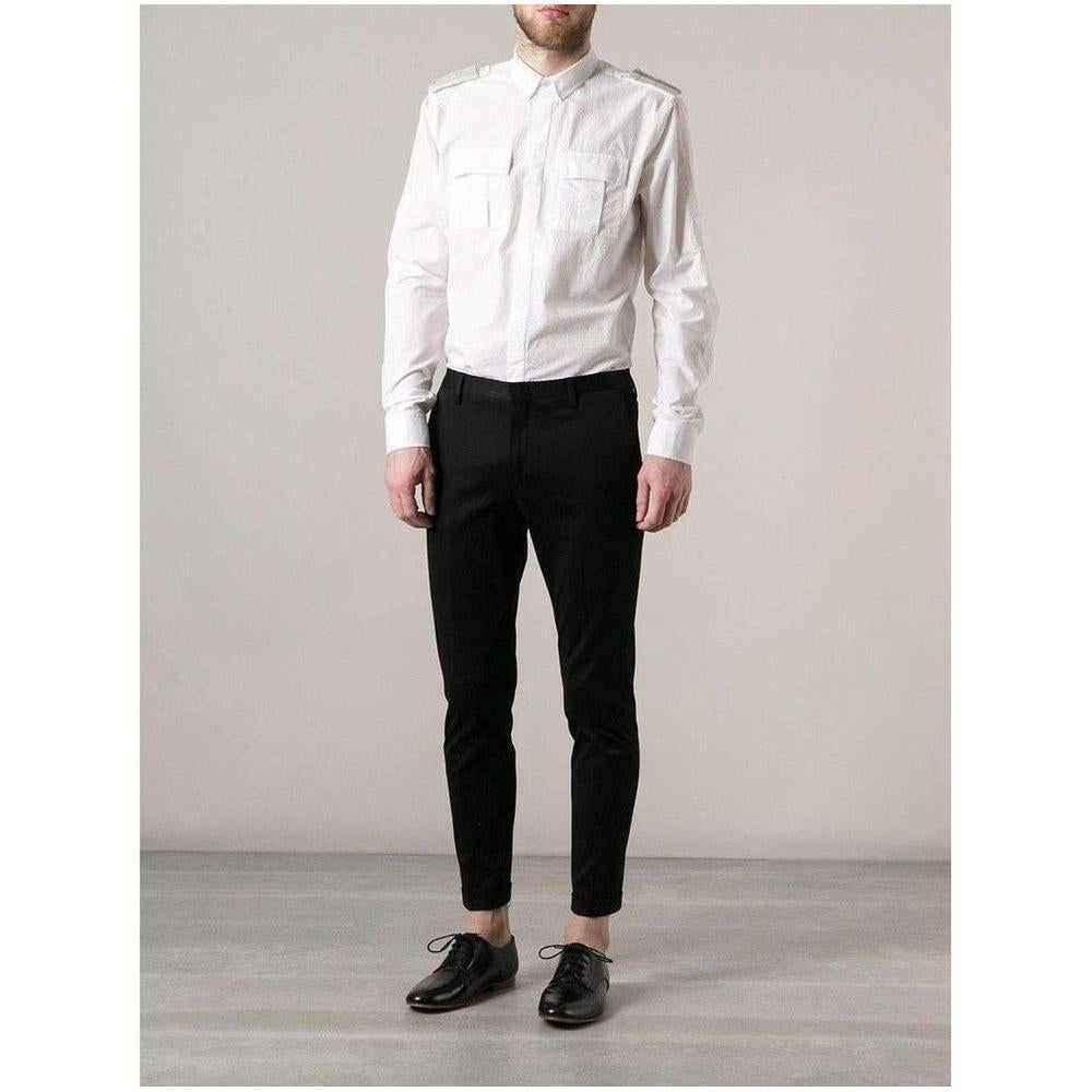 Brand Style ID : S4ht113c472b White cotton shirt from Balmain featuring a classic collar, shoulder tabs, a concealed front fastening, long sleeves, button cuffs and front flap pockets.  Made in France Composition: Cotton 100%