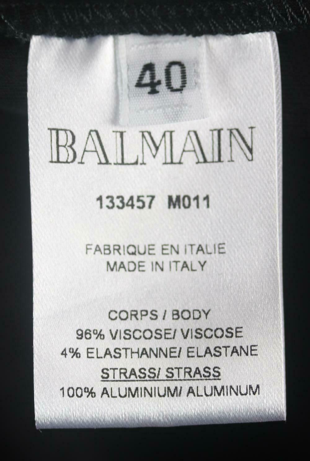 Minivestido de punto elástico Balmain con efecto envolvente y adornos de cristal 1