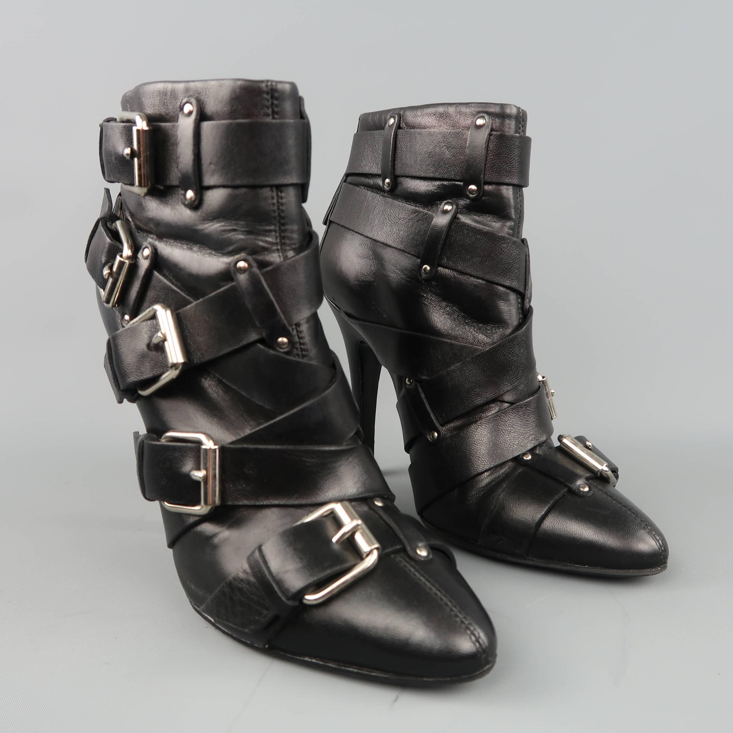 BALMAIN by GIUSEPPE ZANOTTI ankle booties come in smooth black leather with a pointed toe, covered stiletto heel, back zipper closure, and layered belt straps with silver tone buckles. Circa 2010. Skid sole added. Made in Italy.
 
Good Pre-Owned