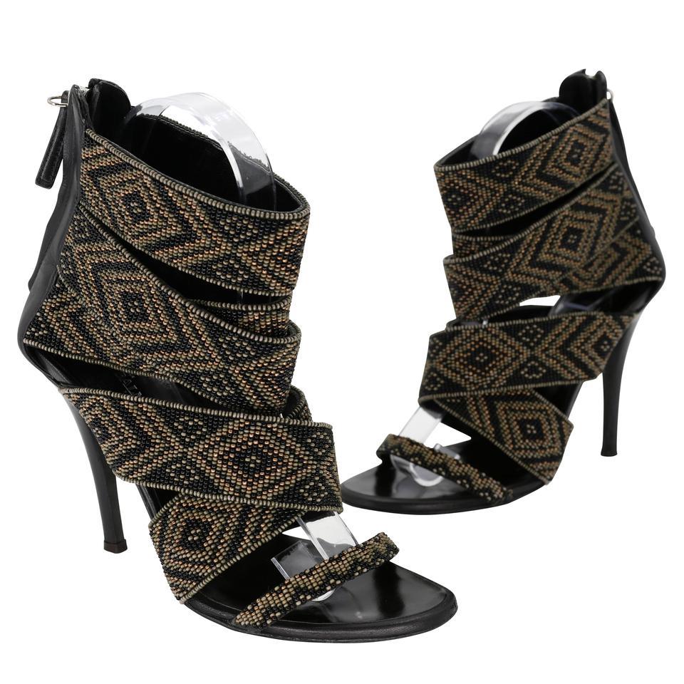 A combo of Tribal Beads and rocking Straps. These shoes zip up the back of the ankle. The zipper has silver metal hardware with a black suede pull tab for easy on/off. There is no missing jewels or beads. The soles have scuffing and signs of wear