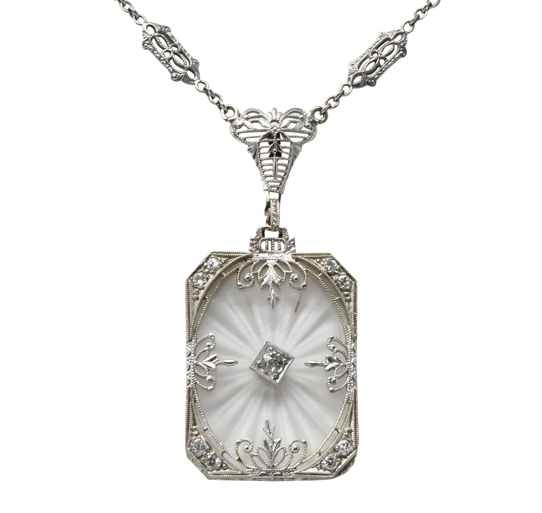 Centering rectangular camphor glass with inset round brilliant cut diamond, set in a millegrain white gold frame

Accented by round brilliant and single cut diamonds, total diamond weight approximately 0.22 carats, eye-clean and white

On an