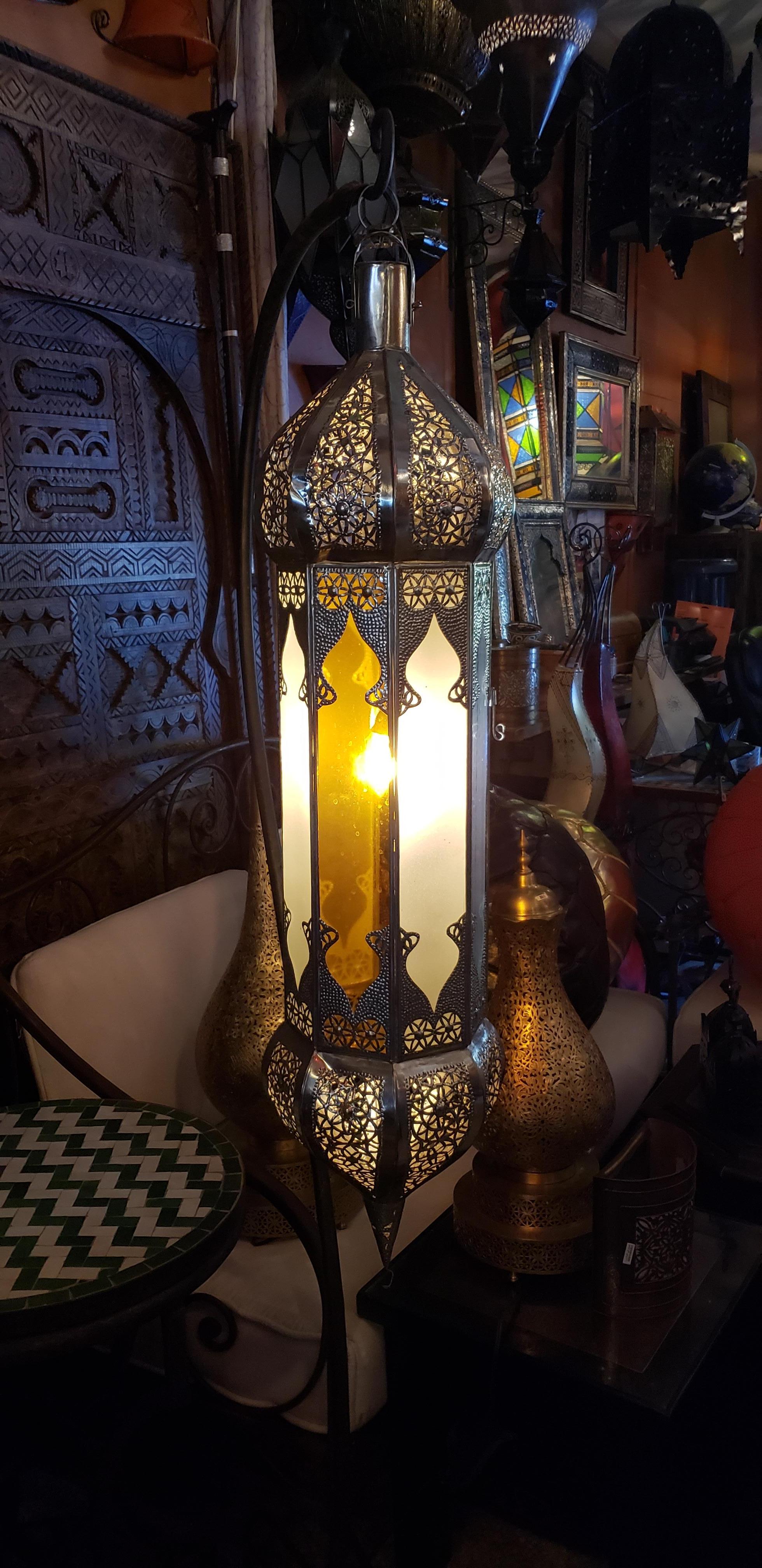 Moroccan handmade metal lantern, as seen in many design magazines. Tall size frosty white, blue, and yellow glass panels on a silver stained frame. This lantern measures approximately 40