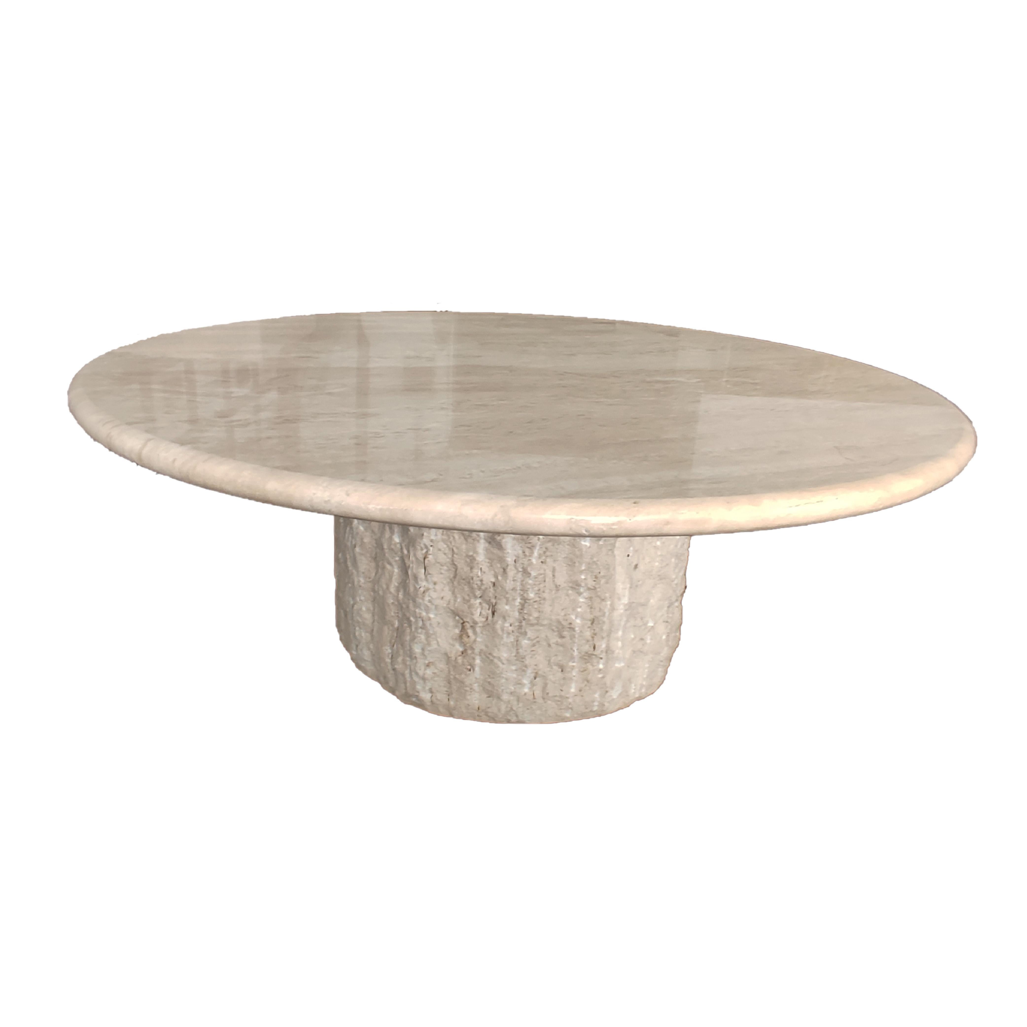 The BALTA coffee table is a coffee table in Roman travertine marble, with round top in polished finish and rounded blunt edge. The circular base is made of Roman travertine marble with a carved finish, which is made by hand with hammer and