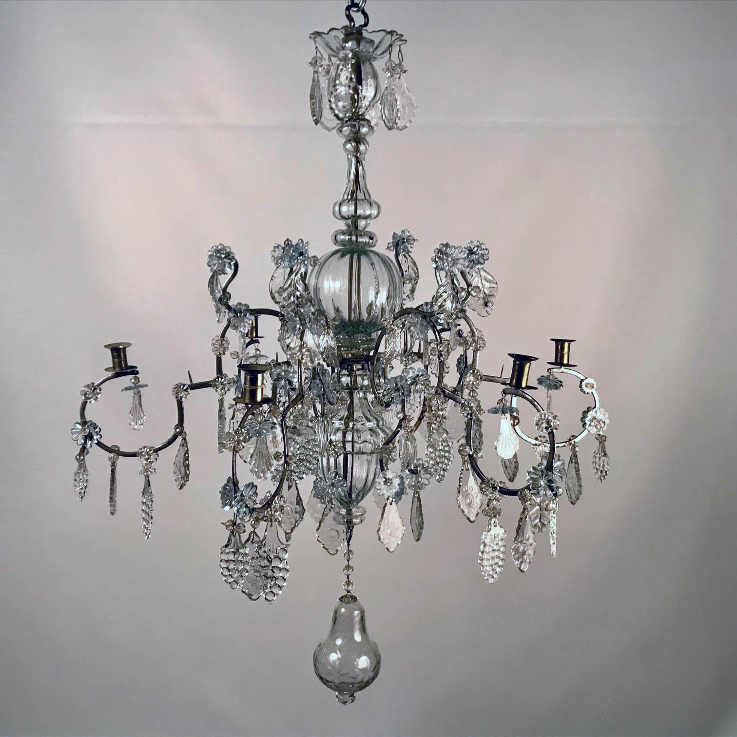 Baltic 18th century crystal and six-arm candle chandelier with antique crystal pendaloques in form of grape clusters, flowers and leaves, hanging from arms leading from central body glass covered stem and finishing with a large pear shaped blown and