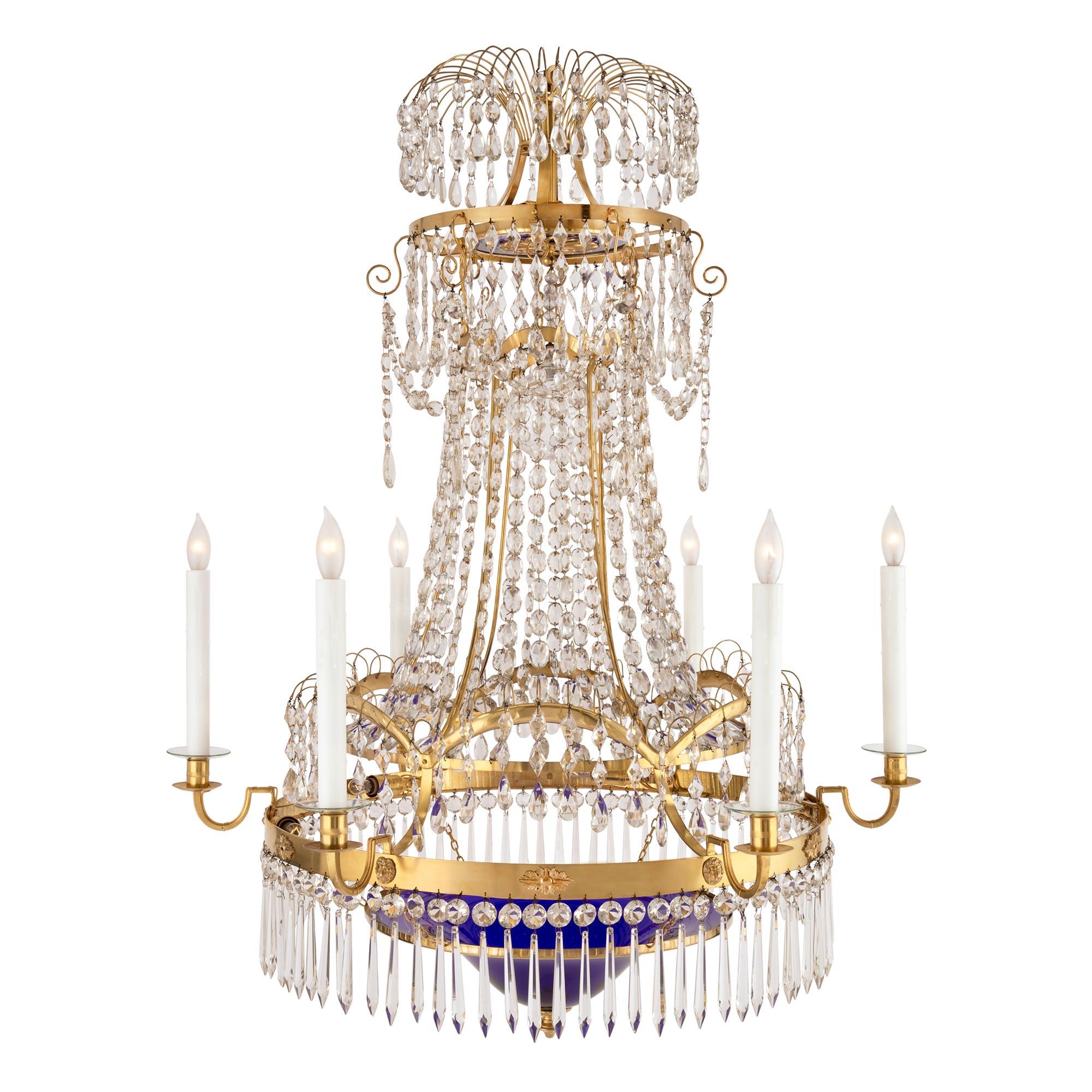 A stunning Baltic 18th century neo-classical st. ormolu, crystal and cobalt blue glass six arm, fourteen light chandelier. The chandelier is centered by a fine bottom ormolu foliate finial below the beautiful original cobalt blue glass with a unique