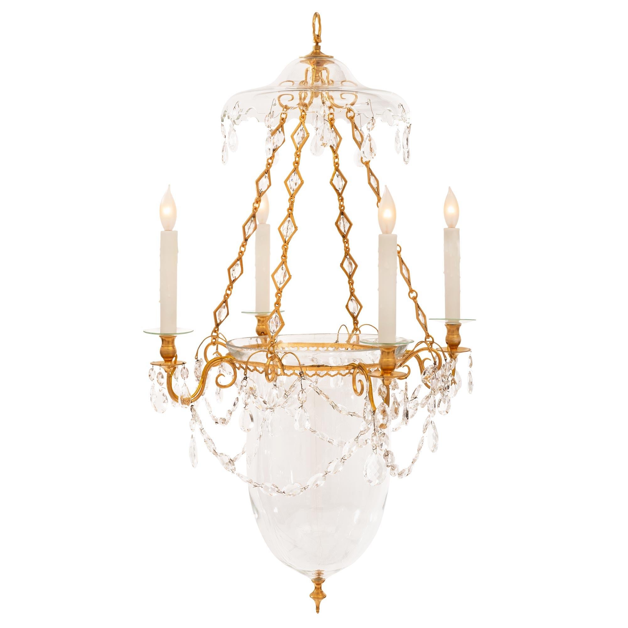 A unique and most elegant Baltic 19th century Louis XVI st. ormolu and hand blown glass lantern. The lantern is centered by a fine bottom ormolu topie shaped finial below the striking and most elegant elongated hand blown bell jar. At the top of the