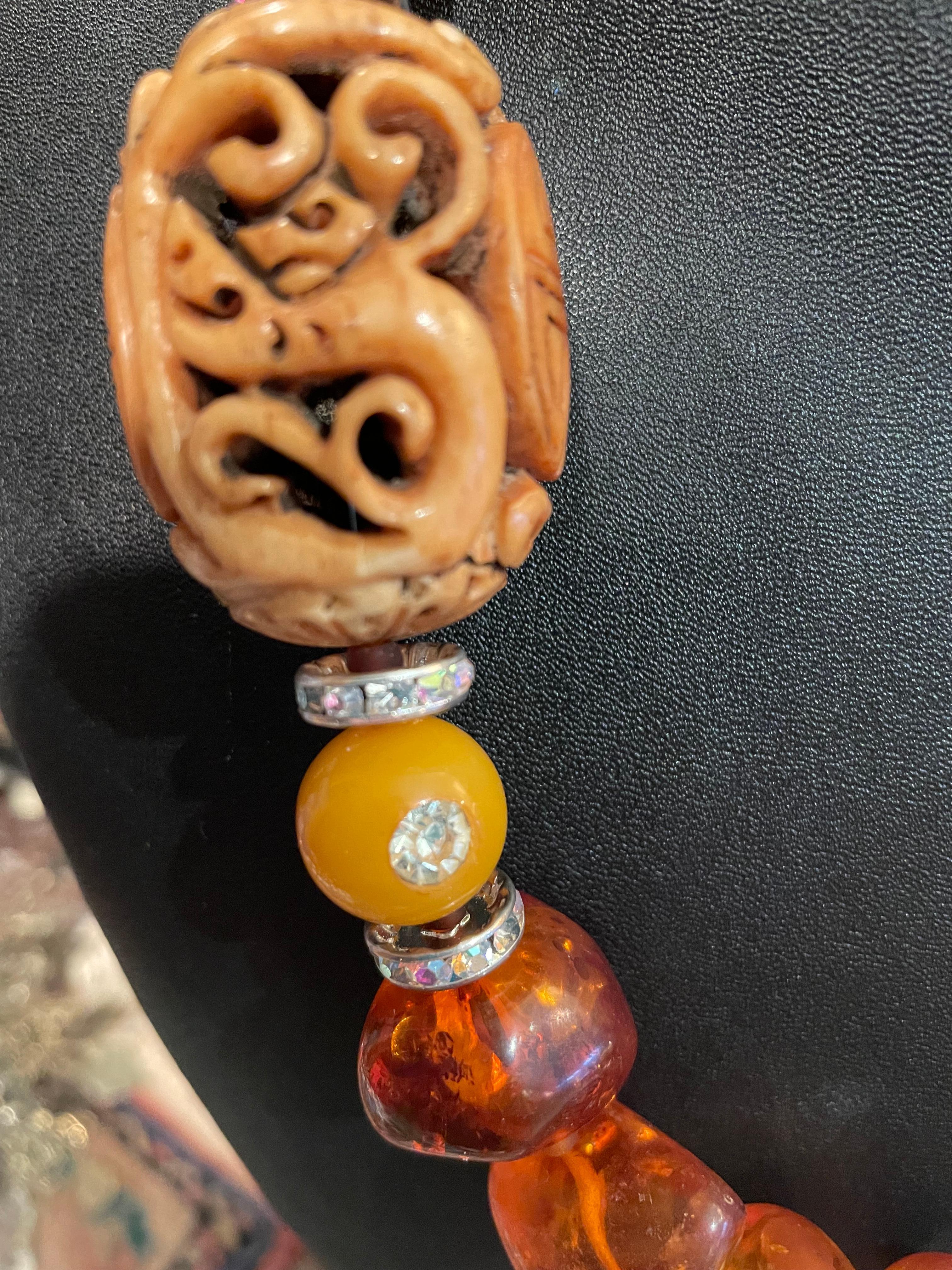 Large chunks of polished Baltic Amber,vintage carved Chinese soapstone bead,vintage Bakelite beads,large Baroque pearls and crystal rondelles comprise this one of a kind ,handmade,necklace. A fabulous offering from Lorraine’s Bijoux and is a real
