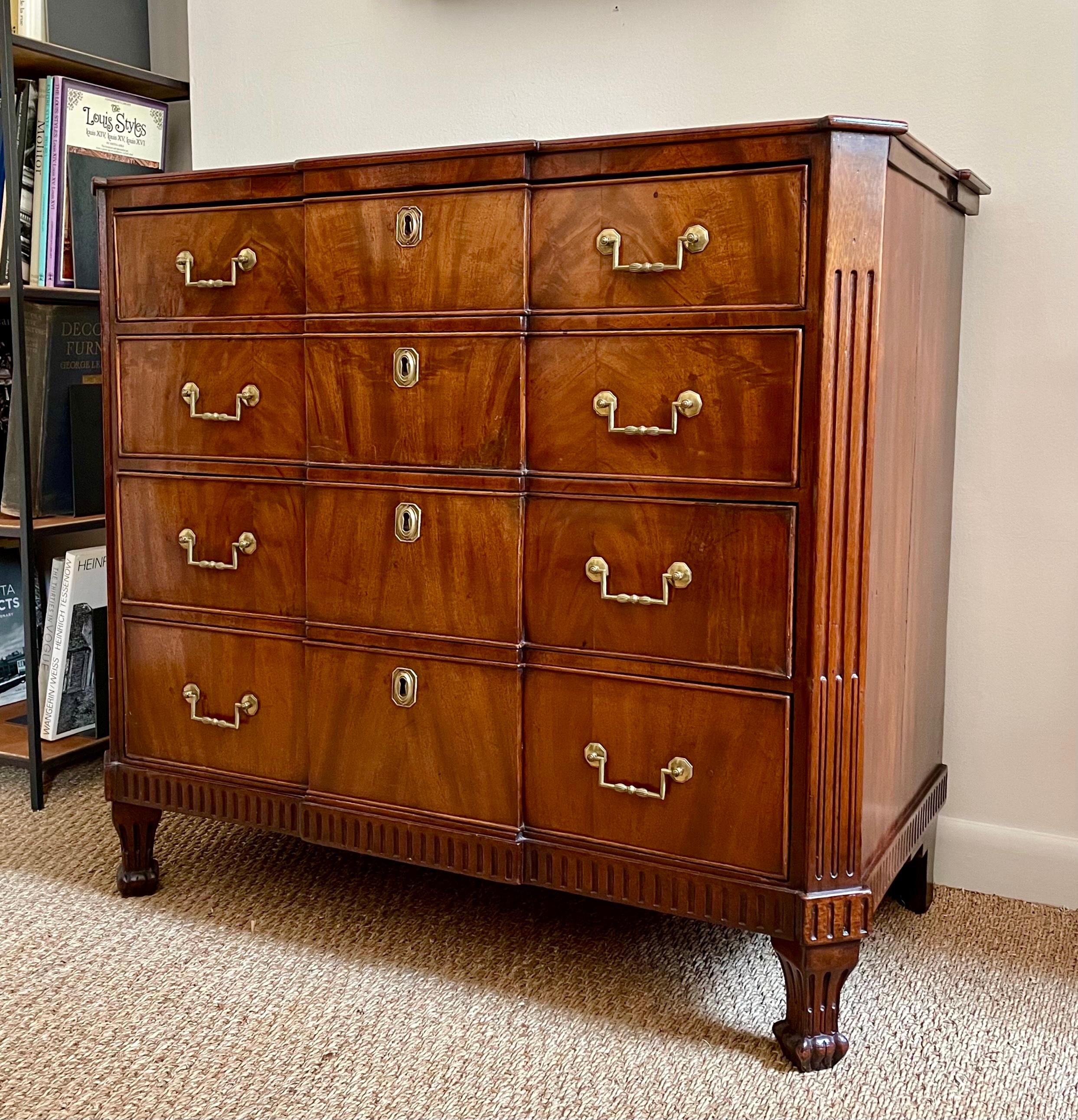 This mahogany commode has the fluted rails and canted corners typical of case furniture made along the coasts of the Baltic and North Seas around 1800. More difficult to pinpoint, however, is the exact place of its making, since this geographical