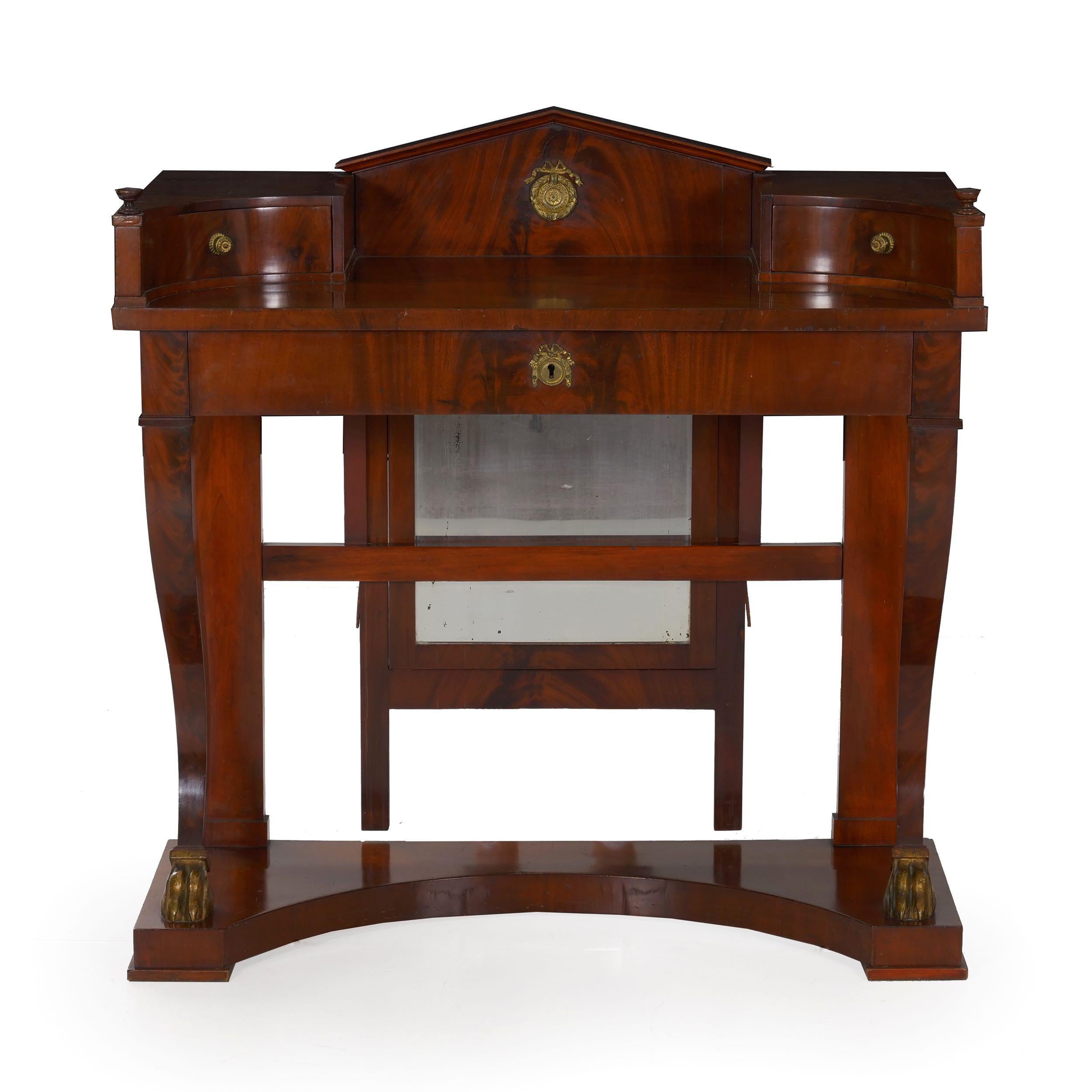An unusual and incredibly attractive dressing table from the second quarter of the 19th century, this piece has been preserved in simply outstanding original condition. Retaining an early silky French polish, the dense flamed mahogany woods