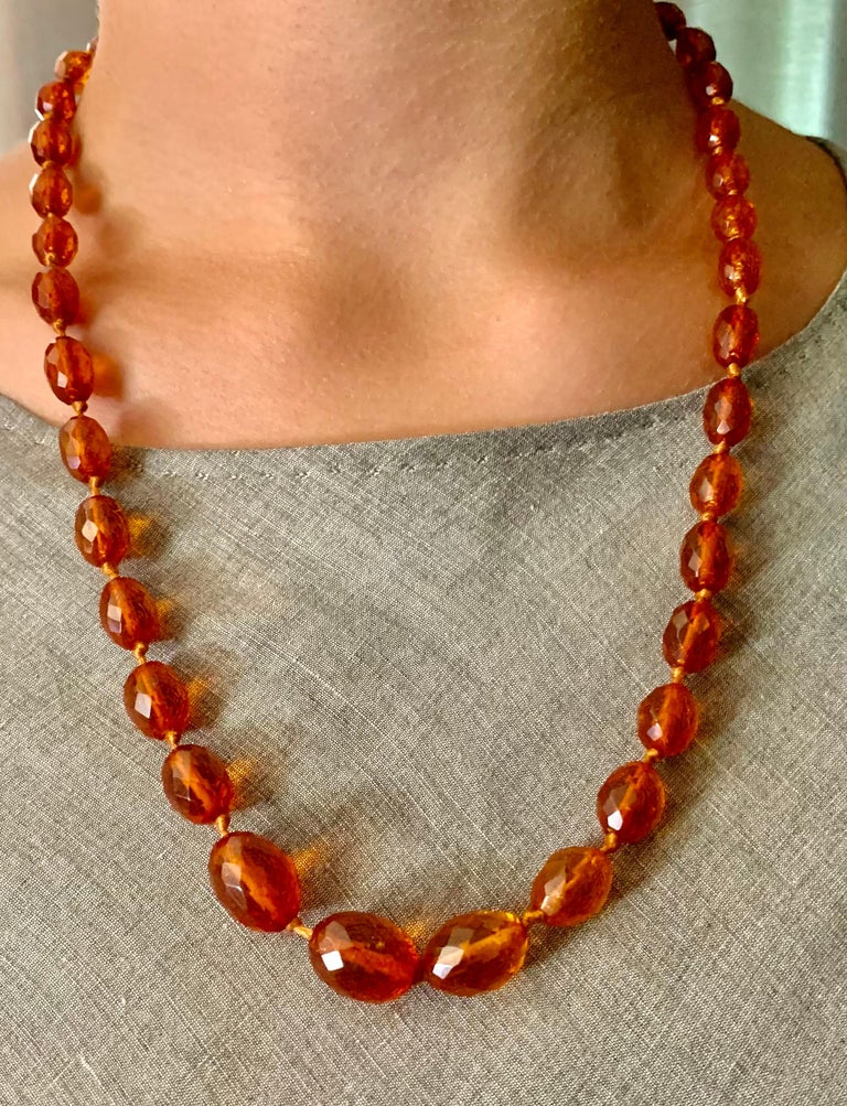 Natural antique honey colored amber necklace composed of 40 oval hand faceted natural amber beads 15mm to 9mm. Very good condition, the beads translucent and showing lovely crazing consistent with antique amber.
Amber has a naturally occurring