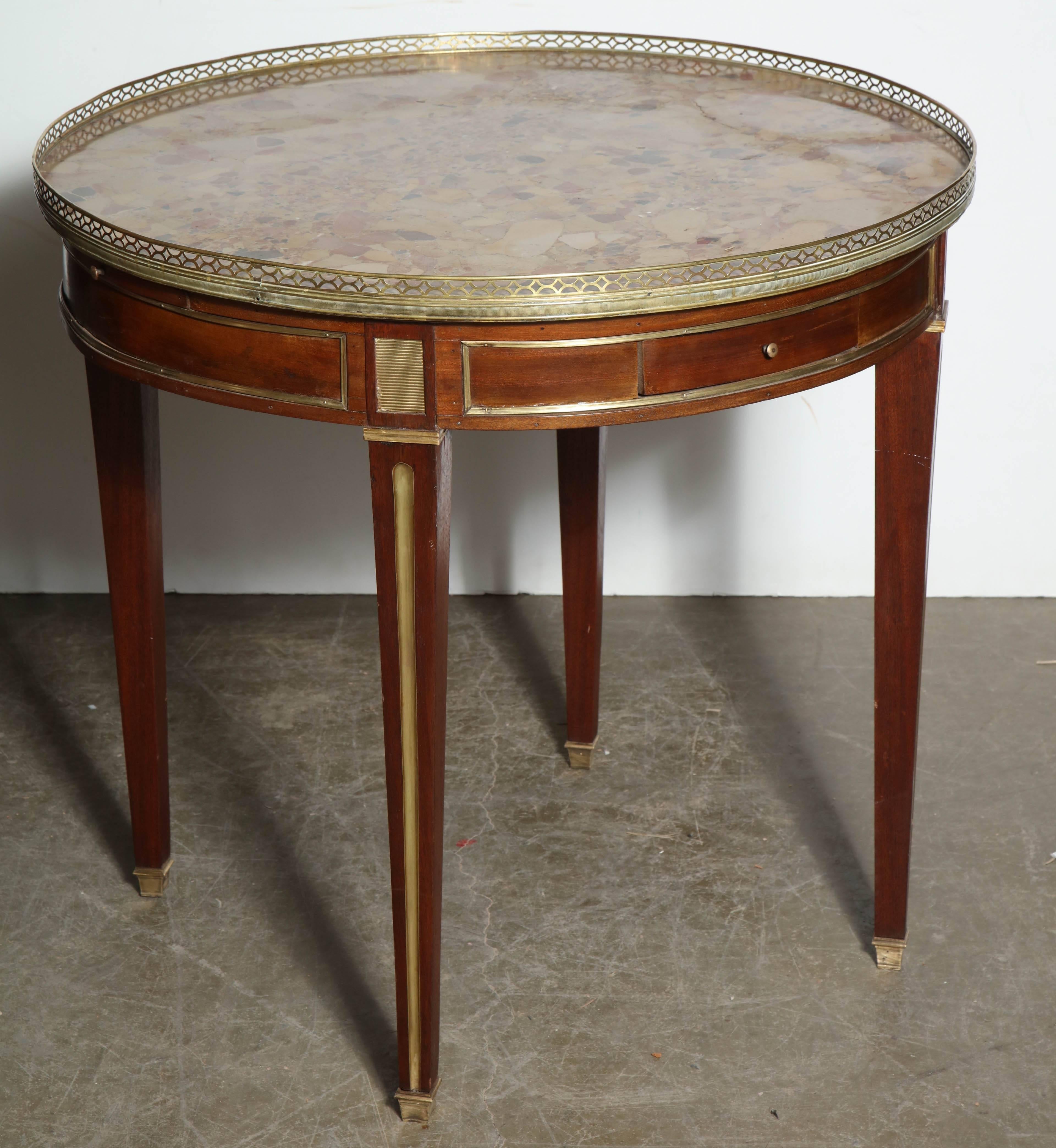 Louis XVI marble top Bouillotte table with pierced bronze gallery, brass trim, two drawers, and two slides.