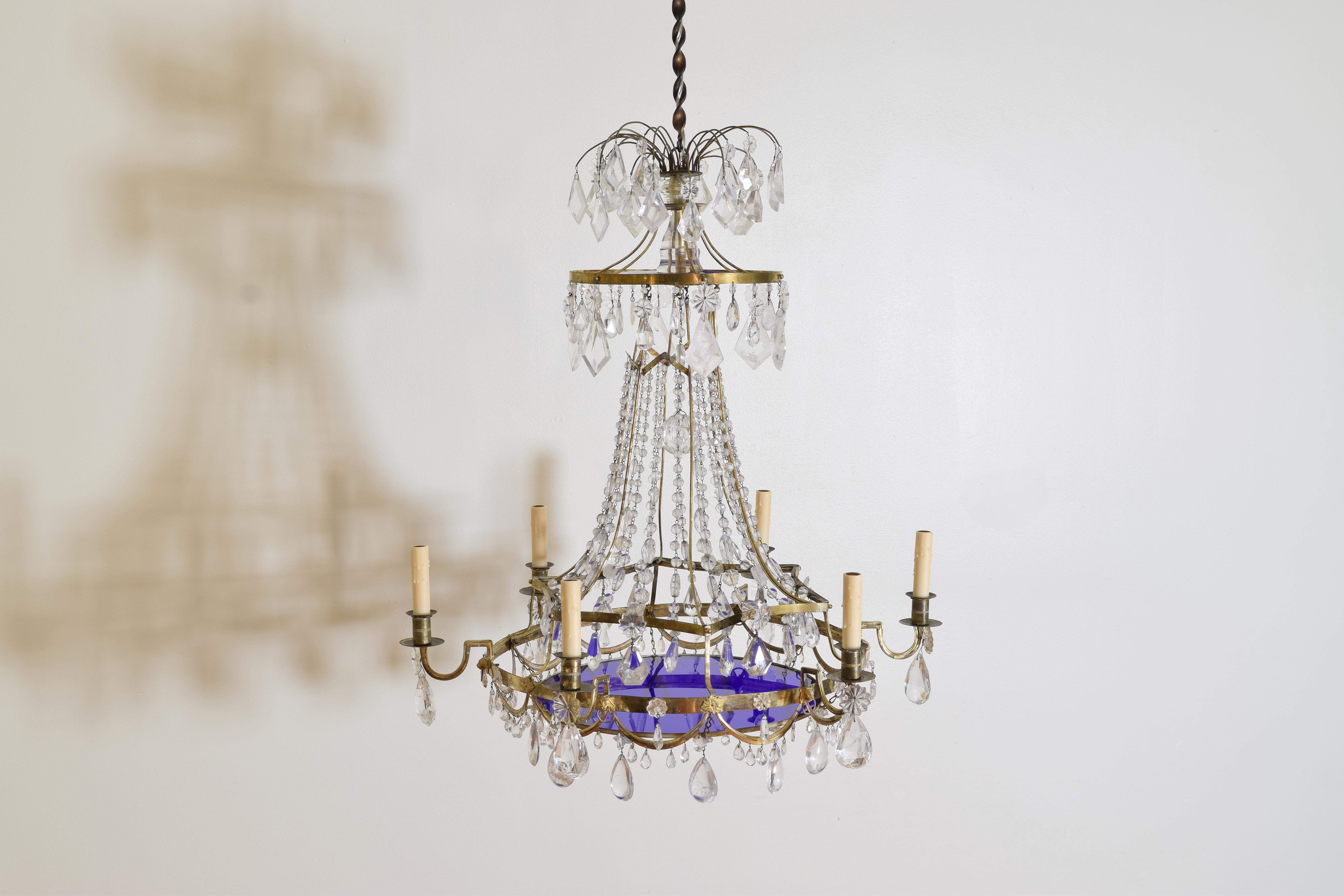 Constructed entirely of ormolu brass with clear glass bead chains, prisms, and a centered faceted hanging sphere, the bottom section with swags and cast rosettes issuing 6 arms, two cobalt blue glass disks, one at the top and one larger at the
